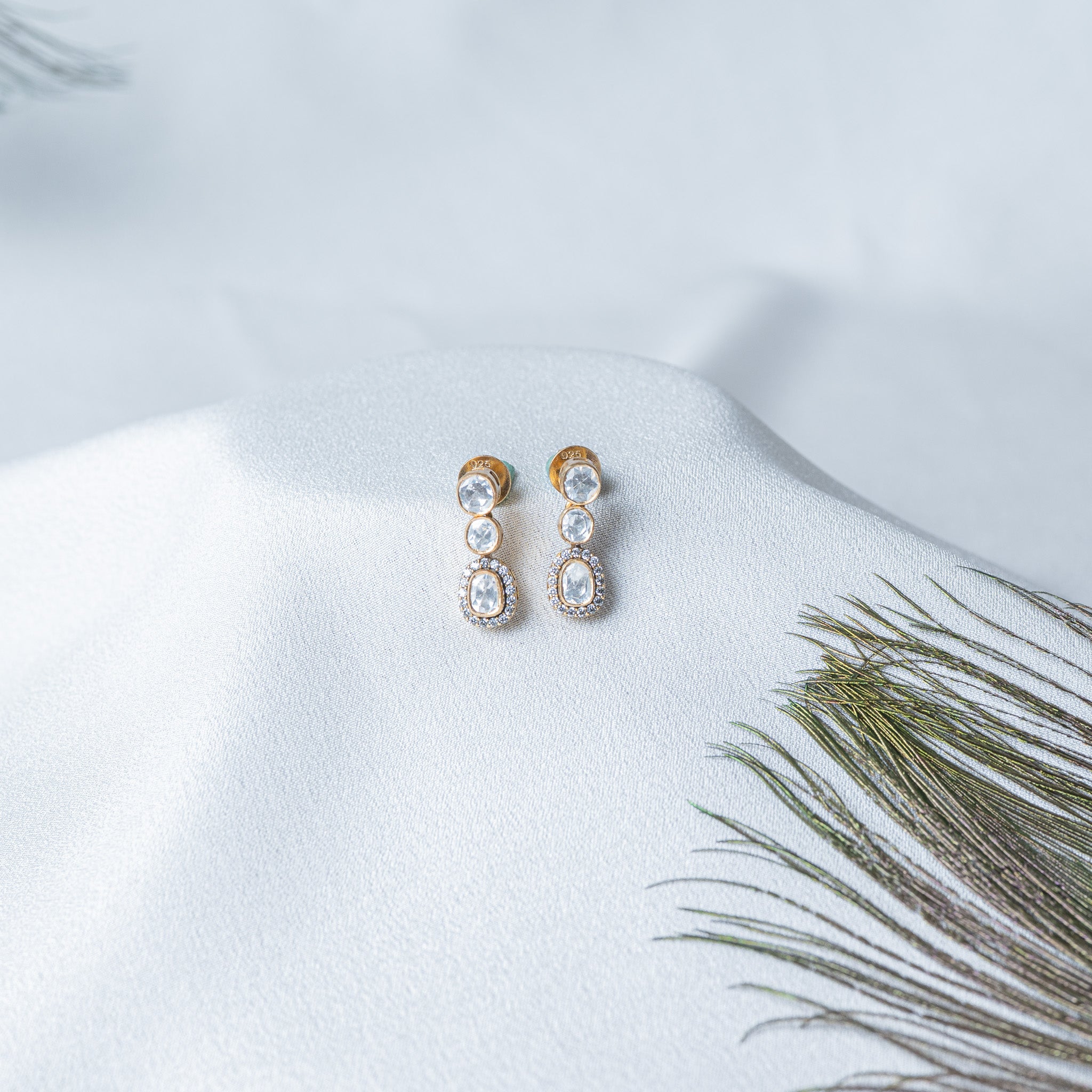 Victorian drop earrings with three graduated uncut stones and a CZ halo on the lowest stone