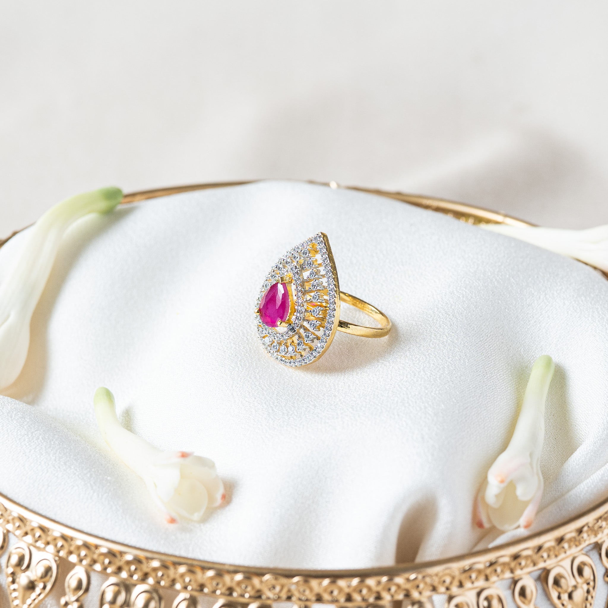 Angled view of the pink teardrop ring showing the height of the prong set centre stone