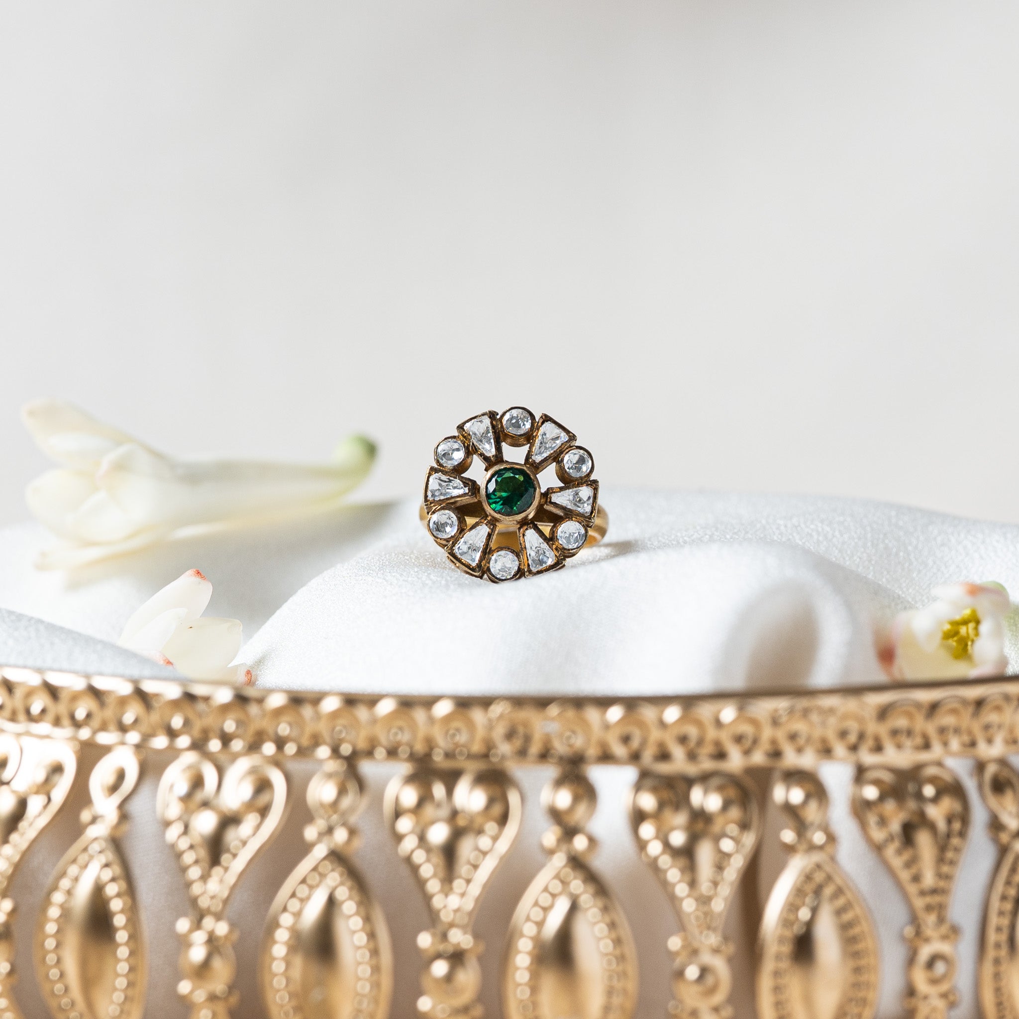 Front view of the rosette ring showing the dark oxidised head against the bright gold band
