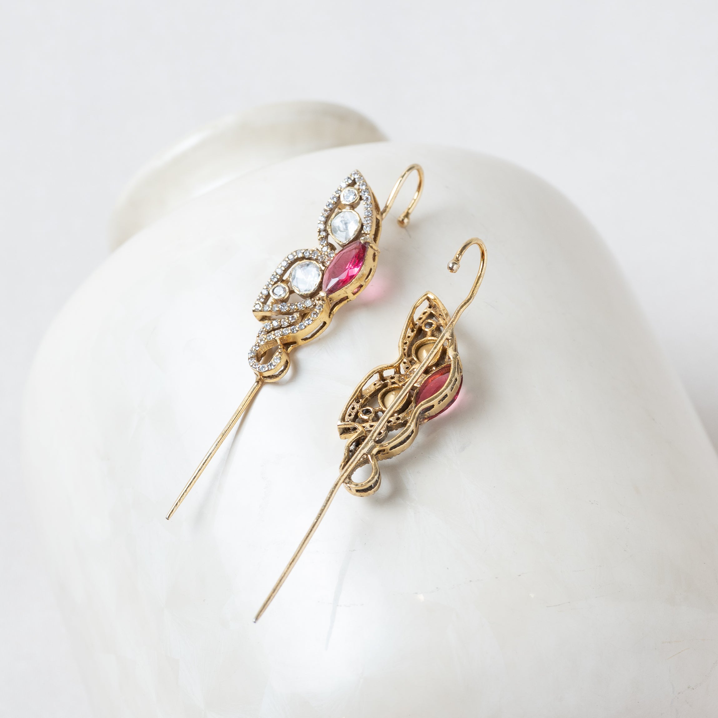 Back of the pink ear cuff showing the lobe post and the open wire that hooks over the ear