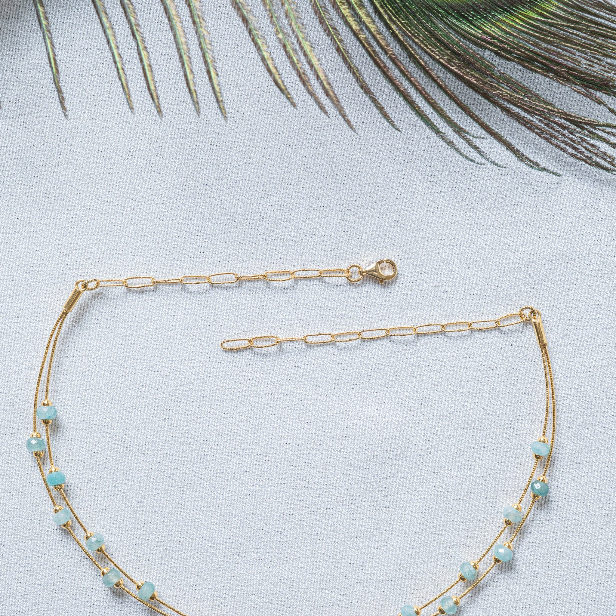 Both open ends flat showing the gold lobster clasp and a paperclip extender at each end