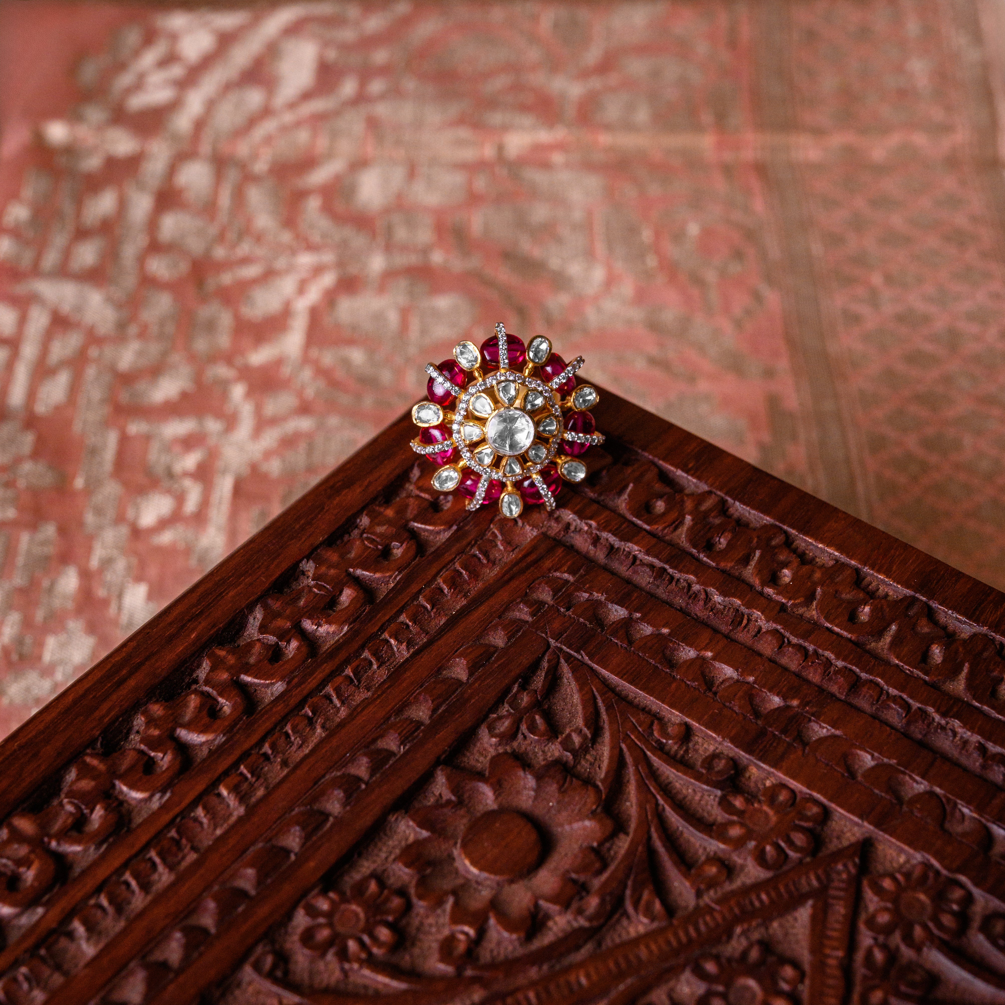 Close-up of moissanite stones and red ruby beads on Zenya Polki silver ring
