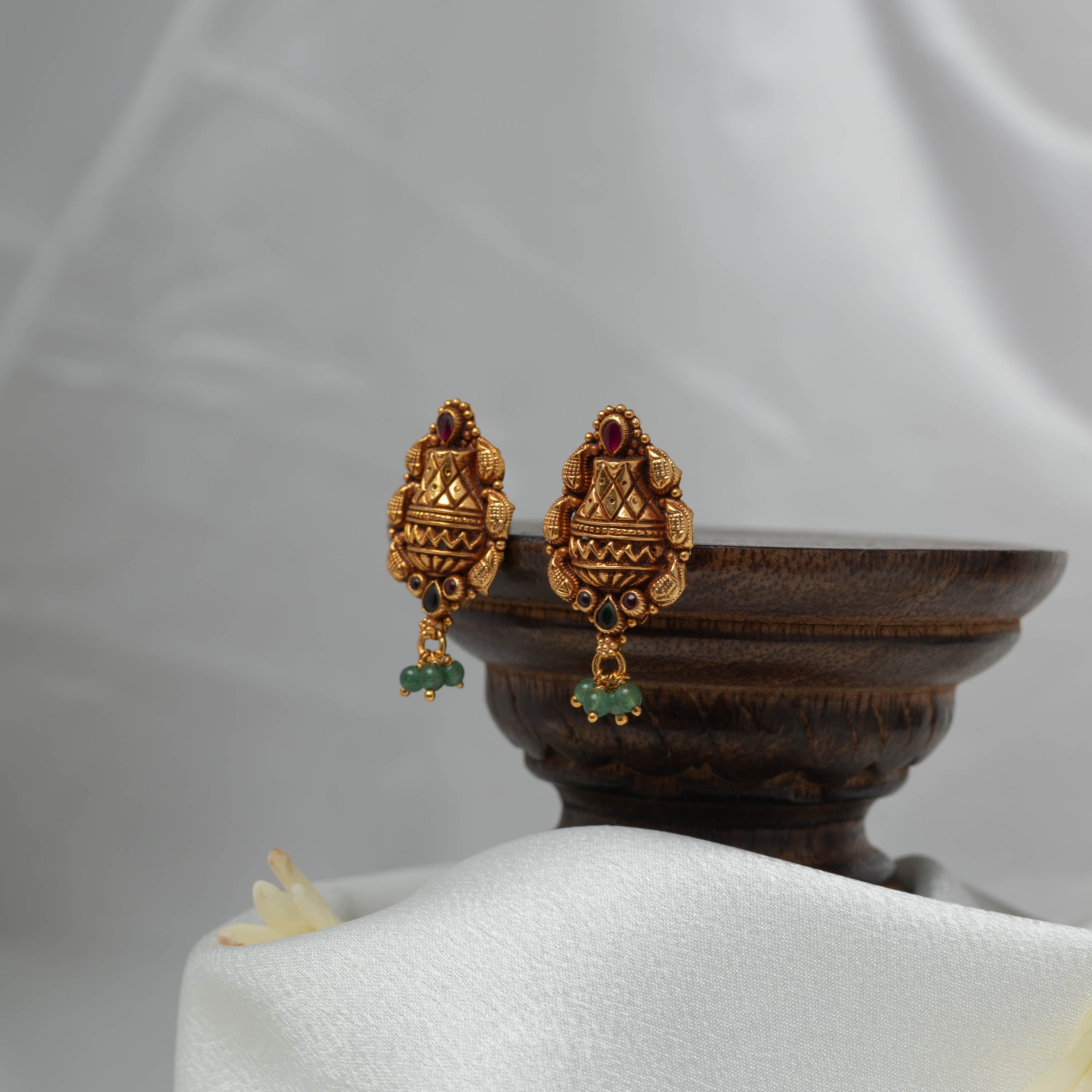 Angled view of the three green bead cluster drops below the kalash temple earring