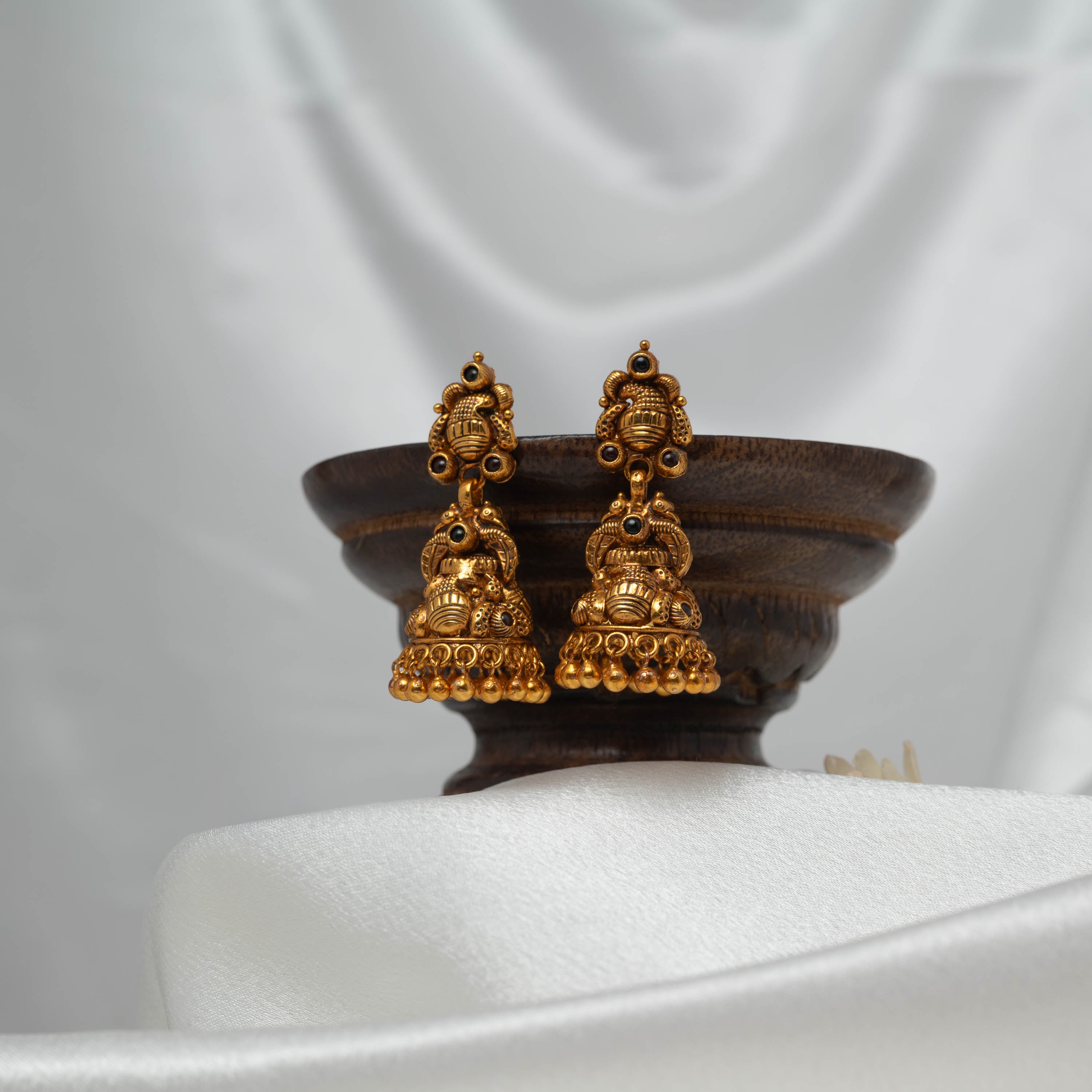Tall temple jhumka in antique gold 925 silver with peacock and kalash tiers and a gold bead fringe