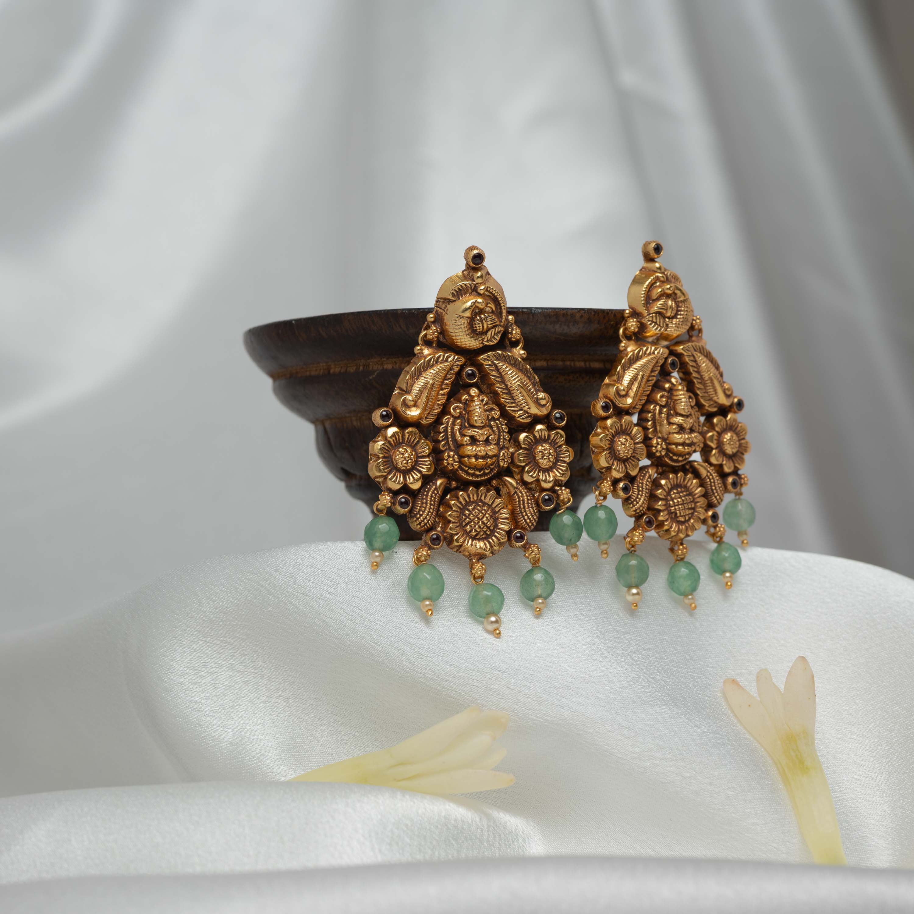 Turned to show the peacock roundel above the fan shaped hangings in antique gold silver
