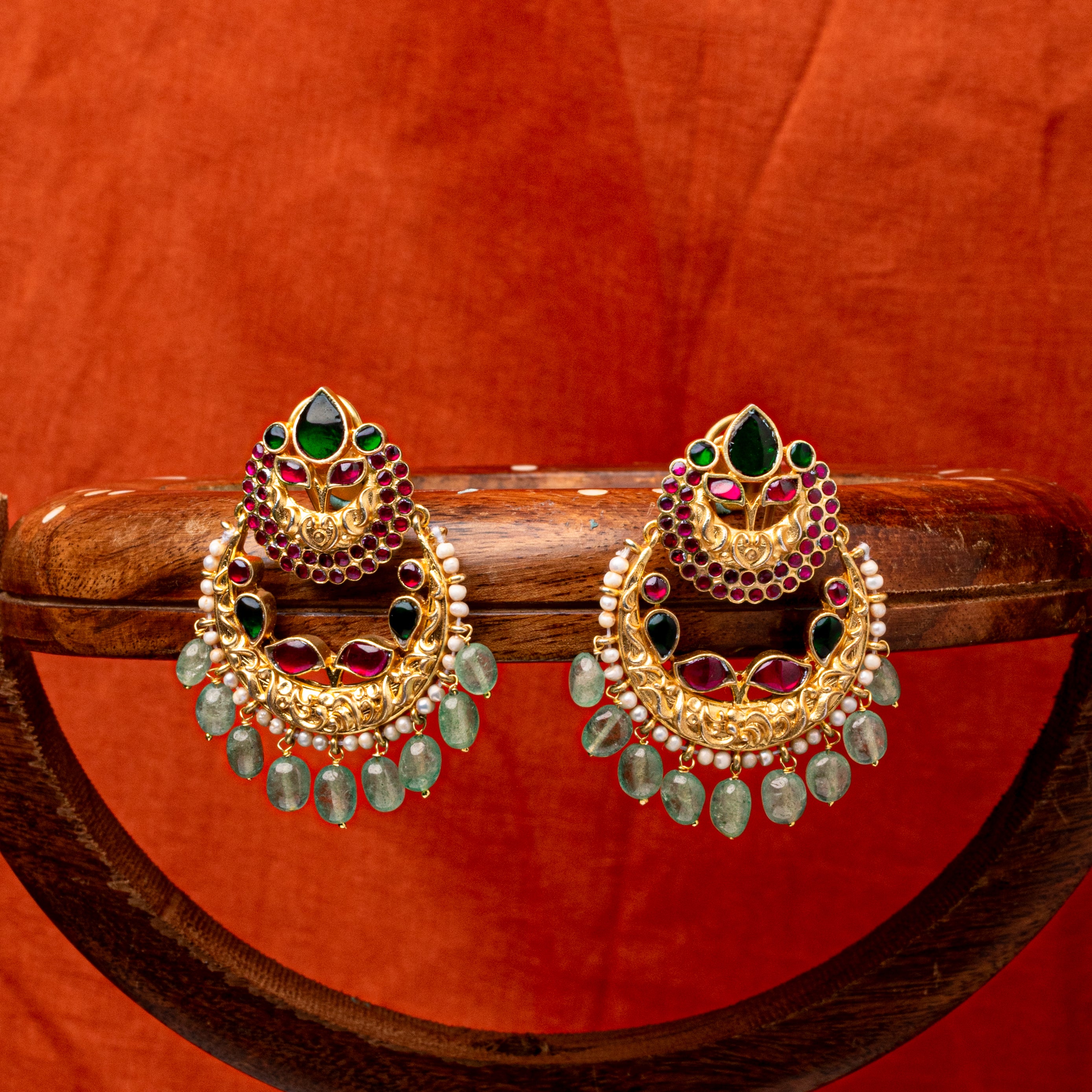 Traditional Kundan chand bali earrings with soft green tumbles and pearl detailing
