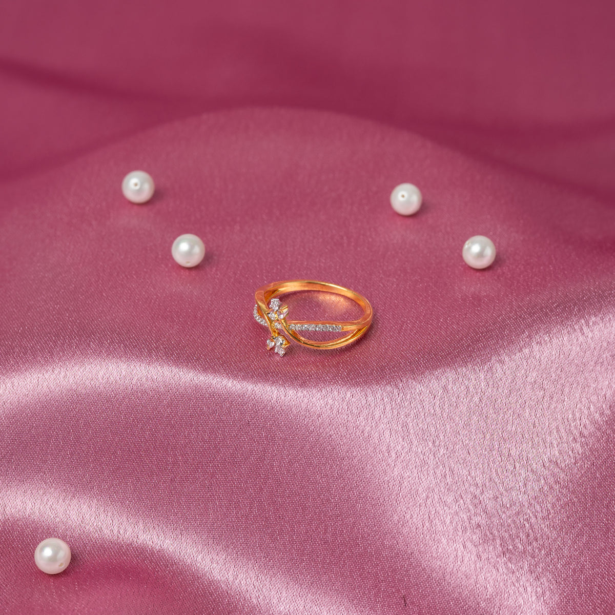 Side profile of the crossover CZ pave ribbon and flower head on a slim silver ring
