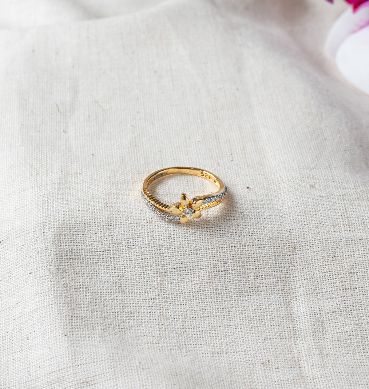 Close view of the flower motif and CZ lined band with the 925 stamp, gold plated silver