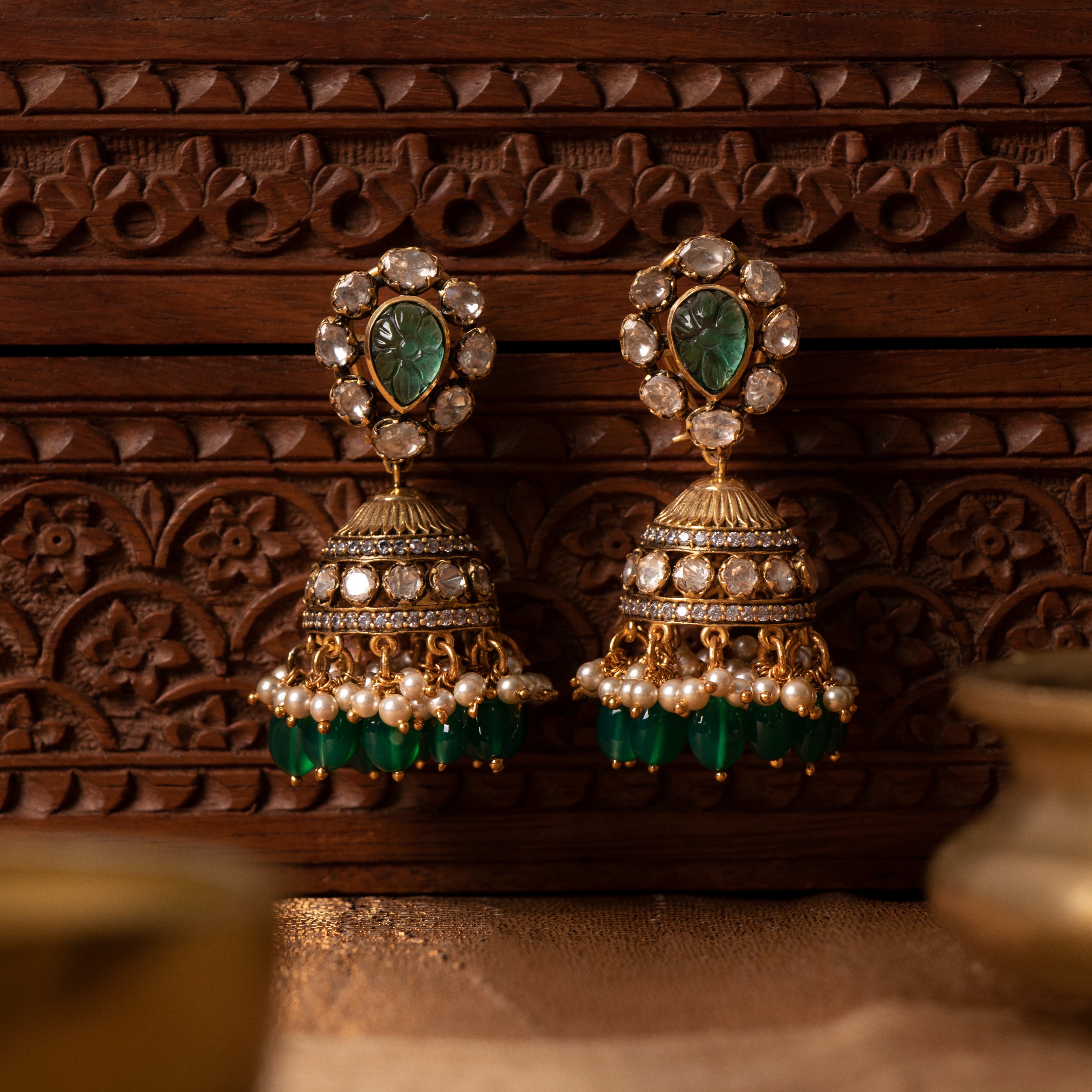 Close-up of Mukhasri silver jhumkas highlighting intricate craftsmanship and stone work