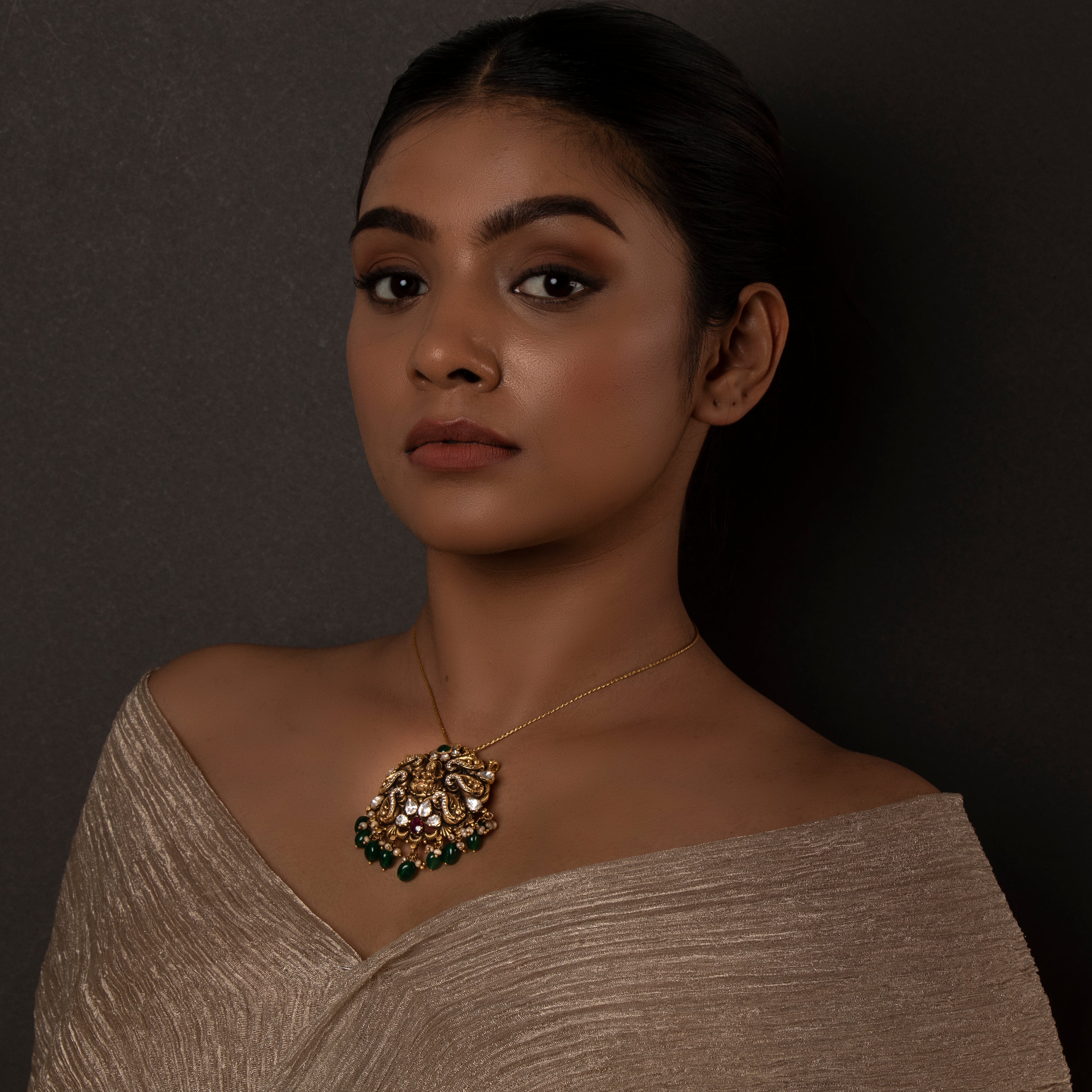 Model wearing Nyura Nakaas 925 silver pendant styled for traditional occasions
