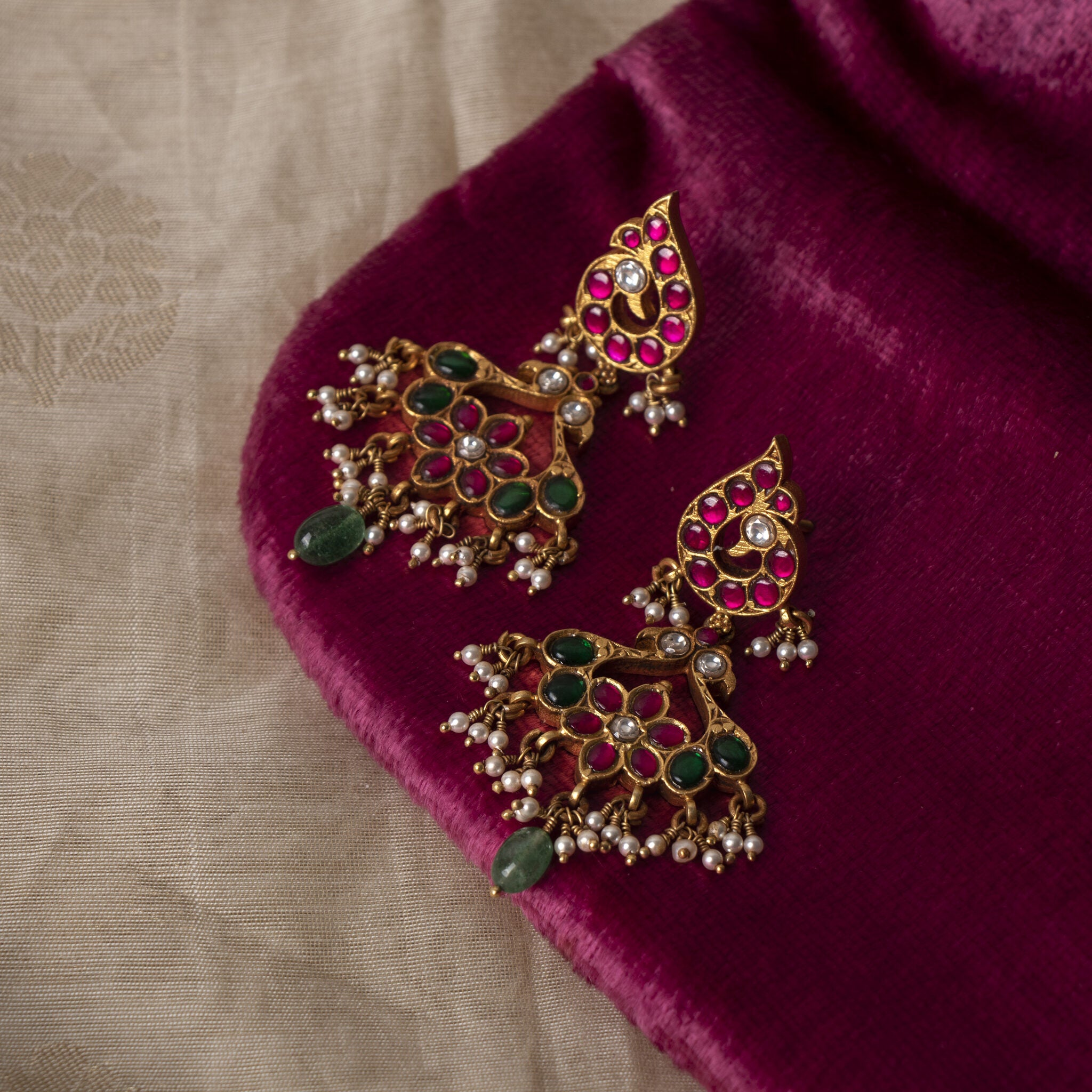 Pair of red kundan paisley tops over flower drops fringed in seed pearls, gold plated 925 silver