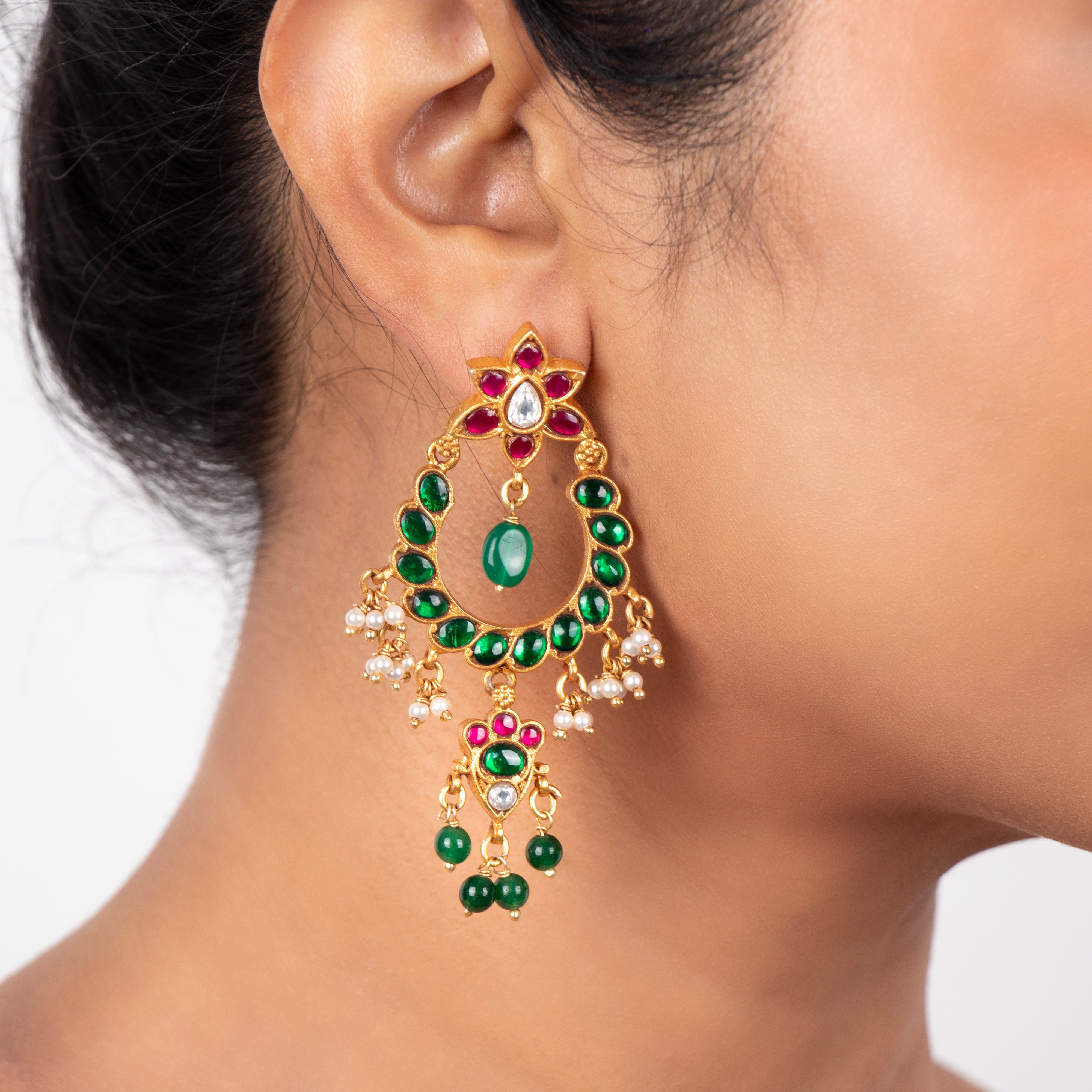 Emerald kundan chandbaalis worn by model, traditional silver kundan earrings for festive wear
