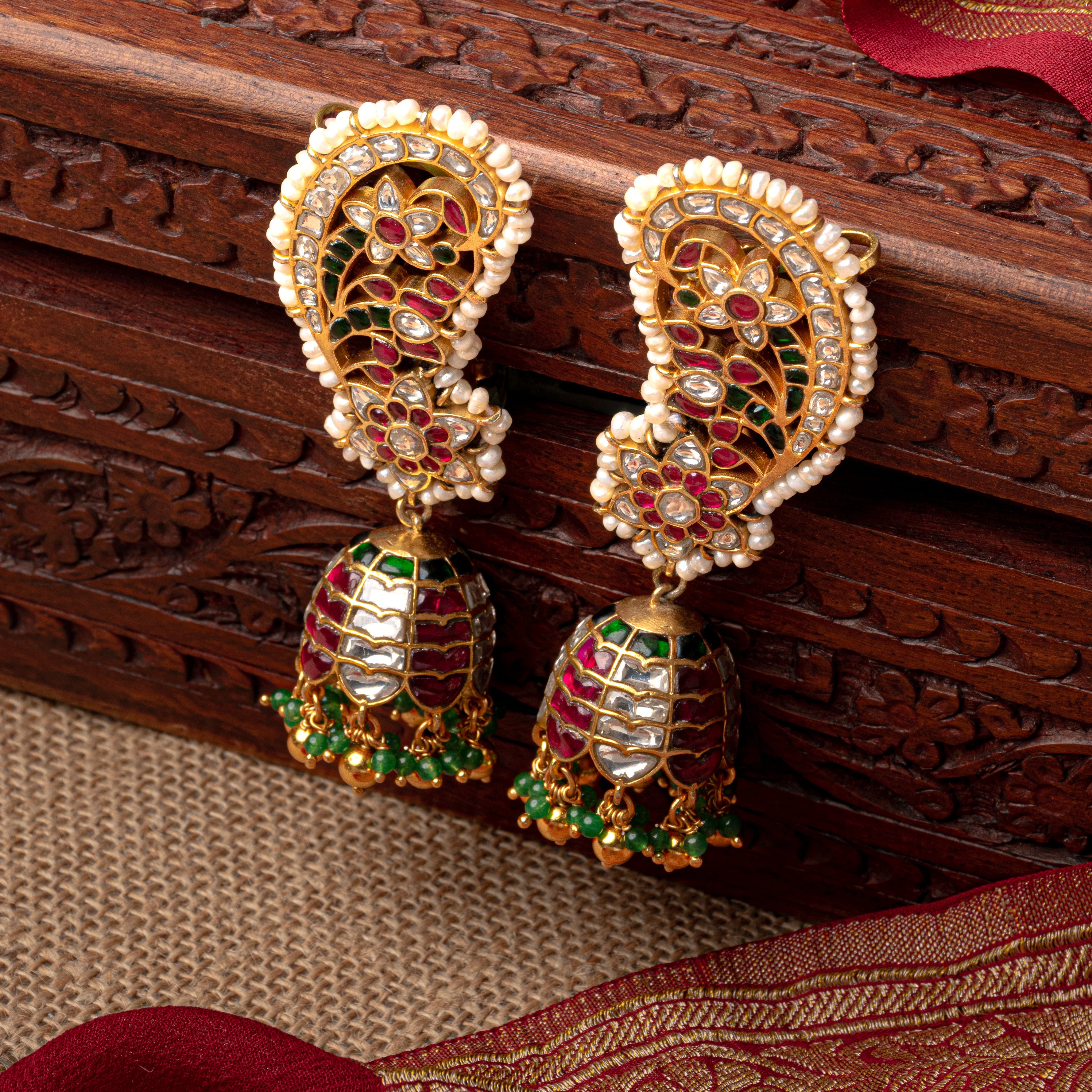 Traditional Kundan jhumka ear-cuff earrings with green bead clusters and rhythmic movement