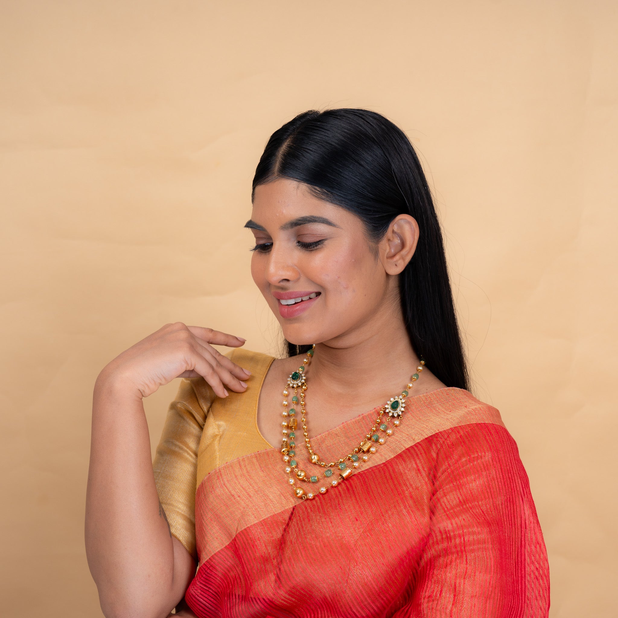Model wearing Raya 3-layer polki necklace with green onyx beads by Aurika