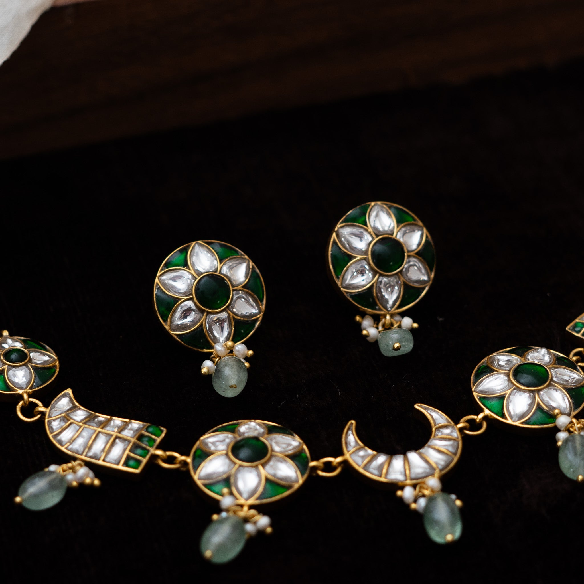 Close-up of Nurvi Jadau necklace showcasing moon motifs, green bead detailing, and elegant craftsmanship