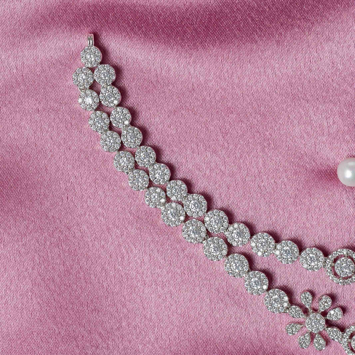 Detail of the dori tie behind the white CZ floral necklace in bright 925 silver