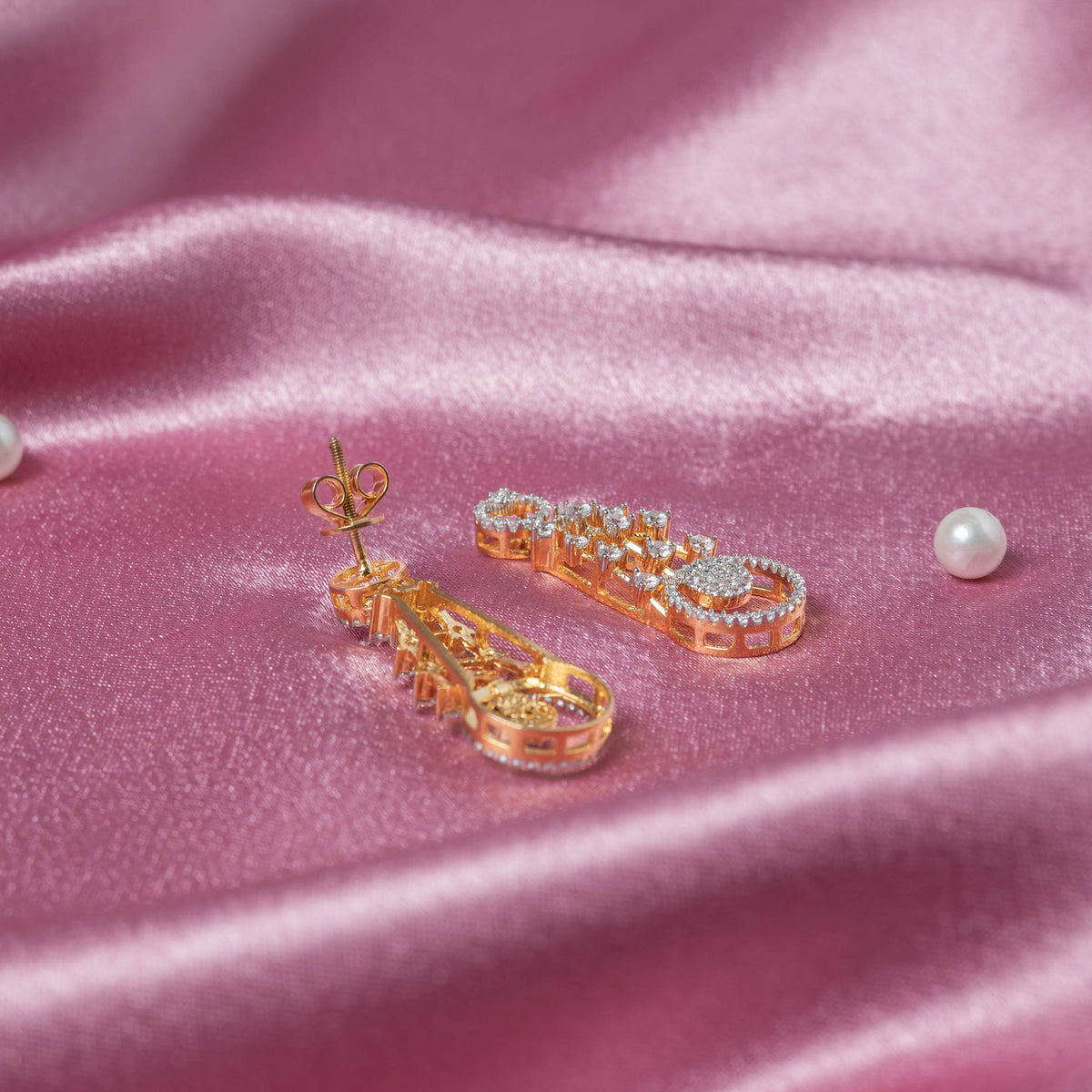 Three quarter view of the circular CZ drop motifs stacked on a pair of sterling silver earrings