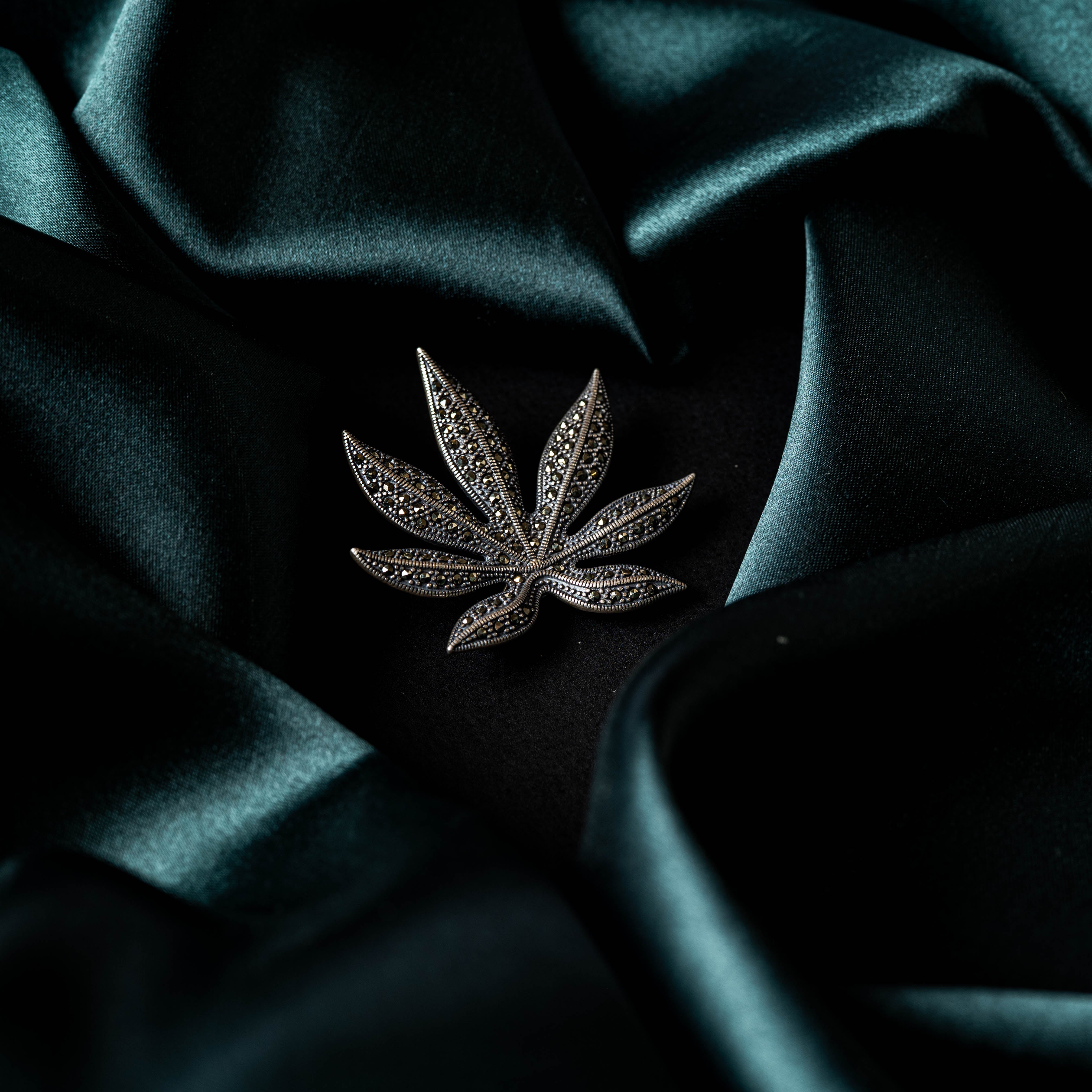 Close view of the marcasite studded veins across the slim leaf petals