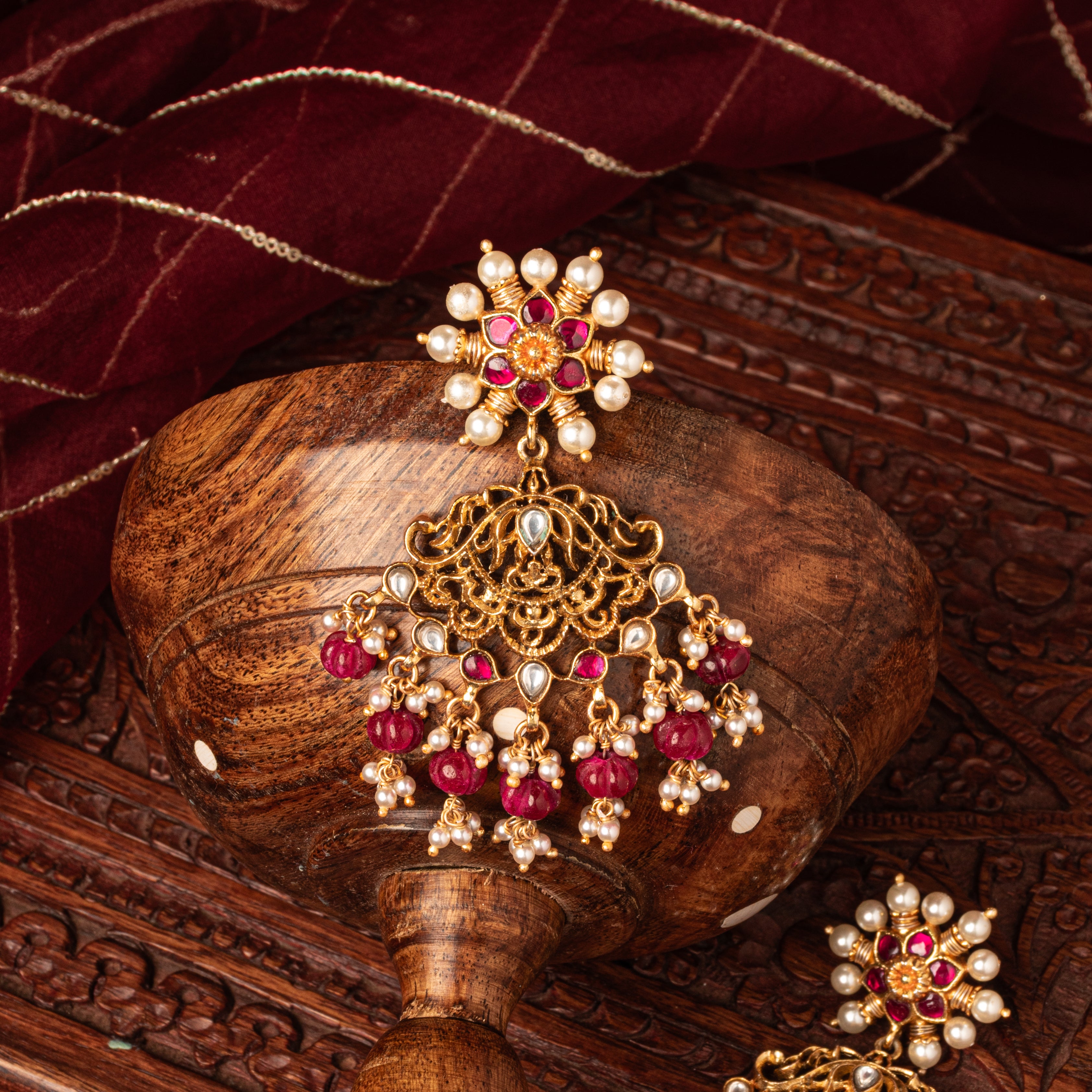 Red bead and pearl fringe at the base of the long kundan earring, antique gold finish 925 silver
