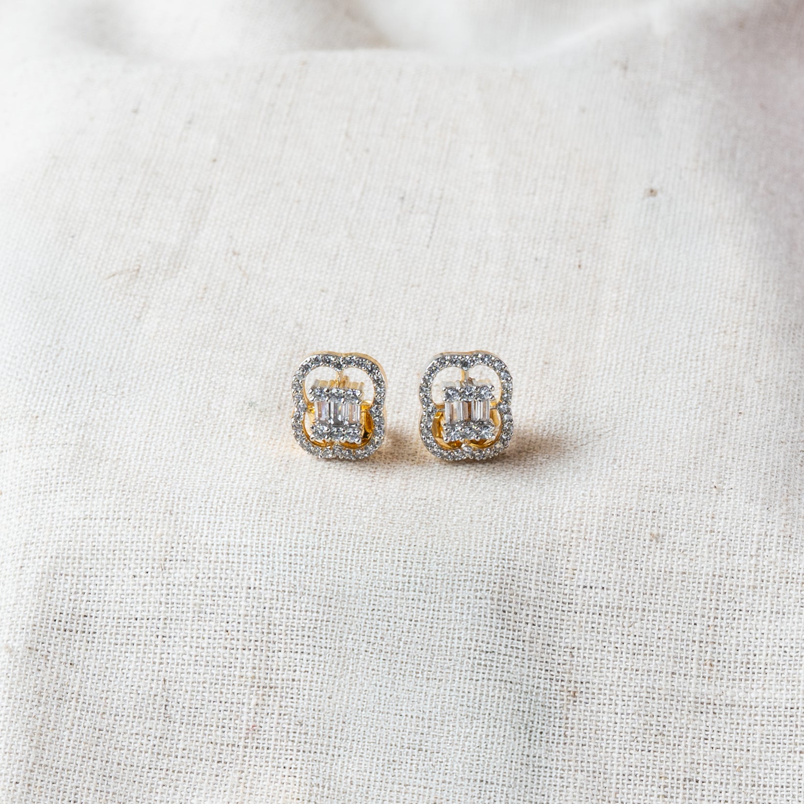 Clover shaped pendant and matching studs set with baguette CZ stones, gold plated 925 silver