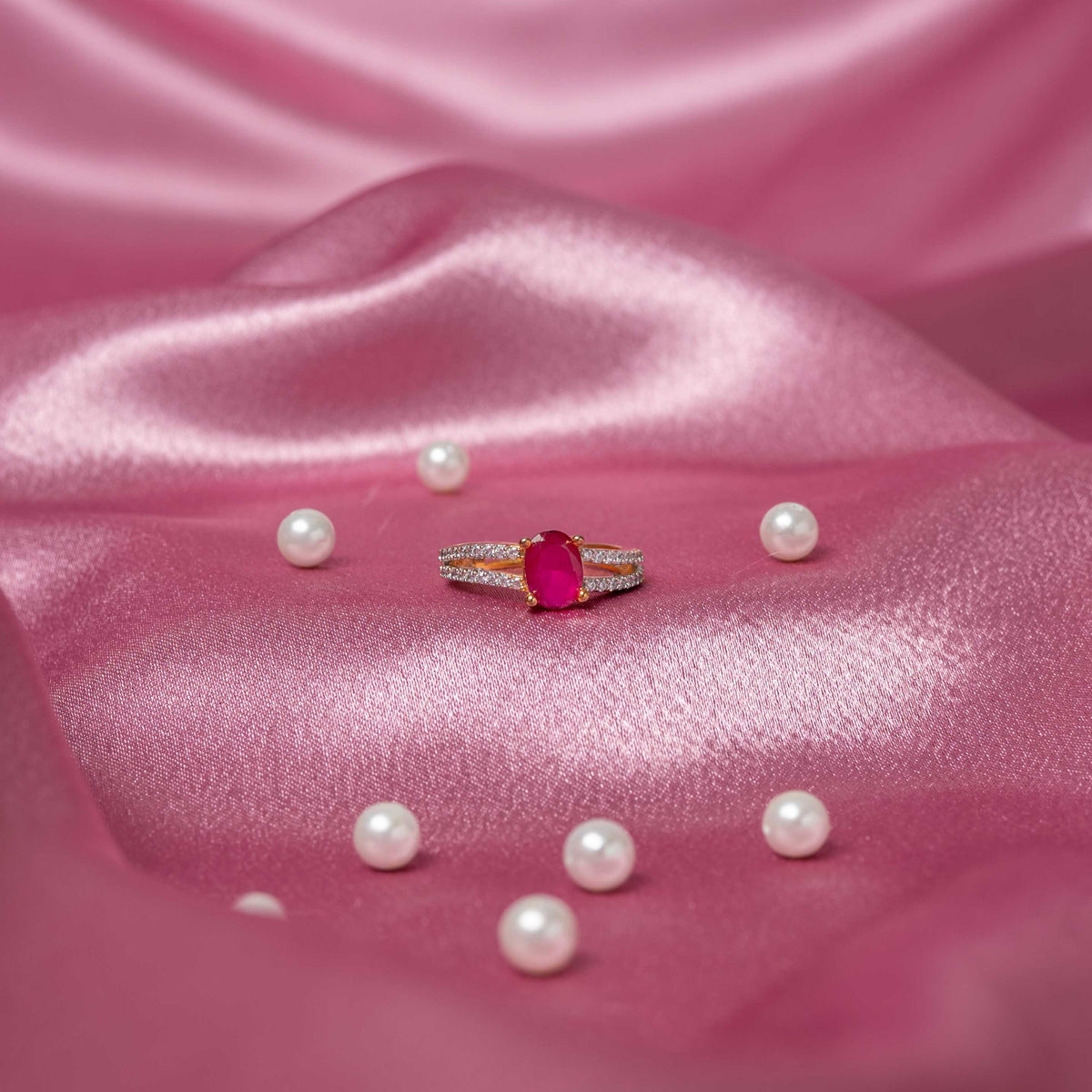 Oval ruby-red ring with white CZ frame and adjustable band in 925 silver