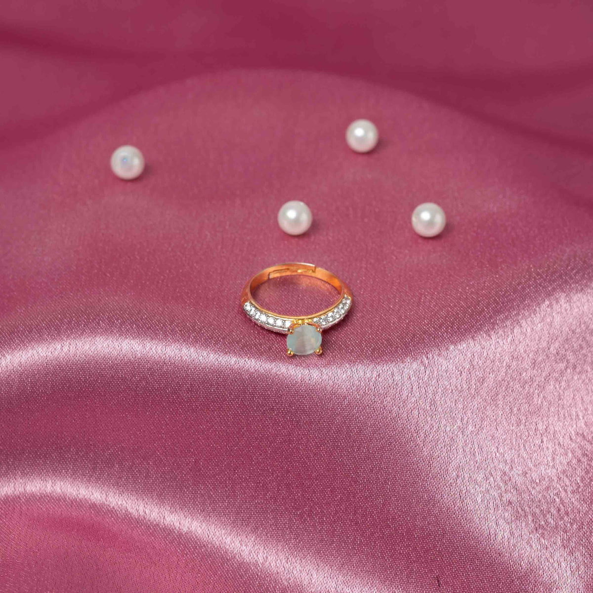 Turned to show the pale turquoise centre stone and CZ pave shoulders on an open silver band