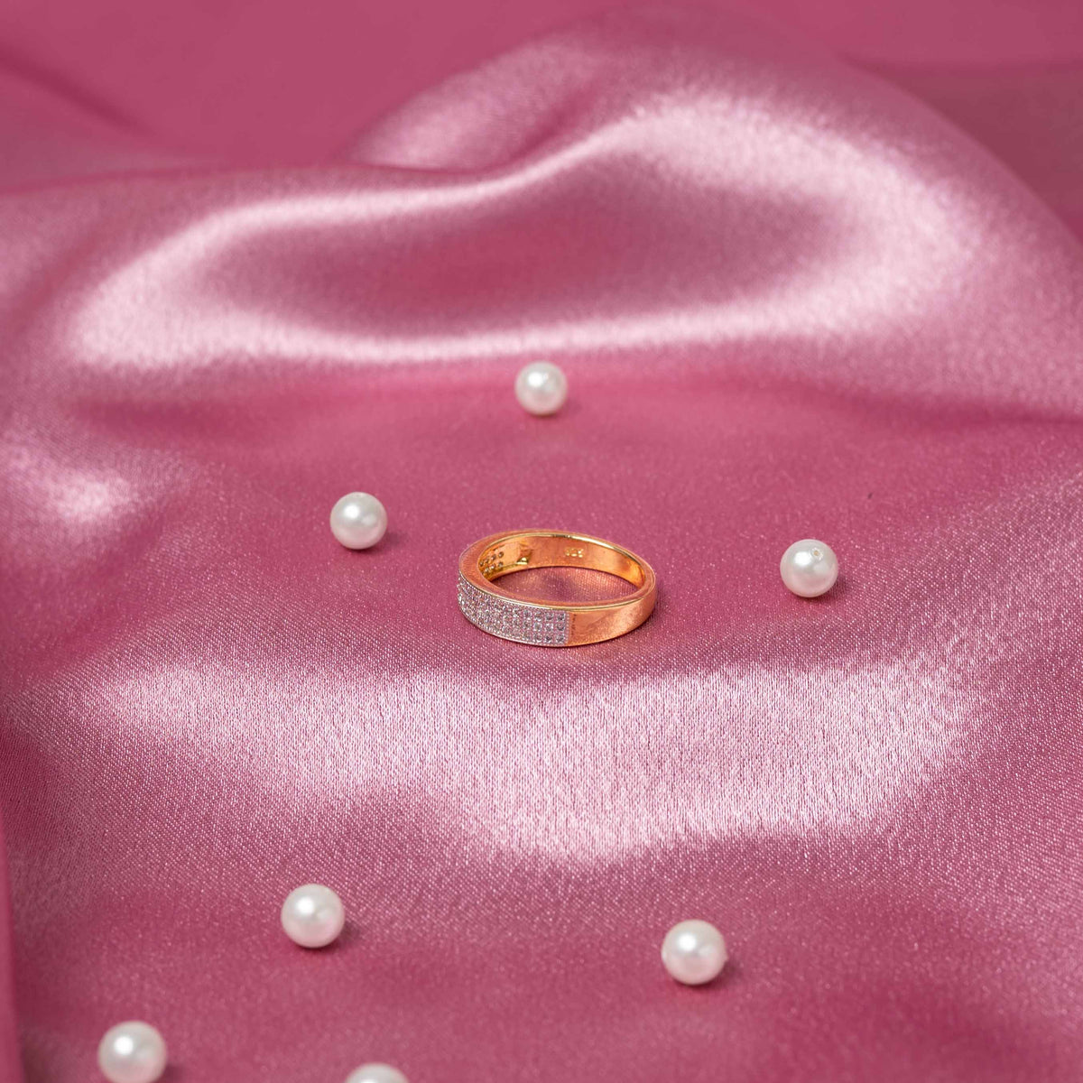 Three quarter view of the claw set round CZ raised above a plain sterling silver band