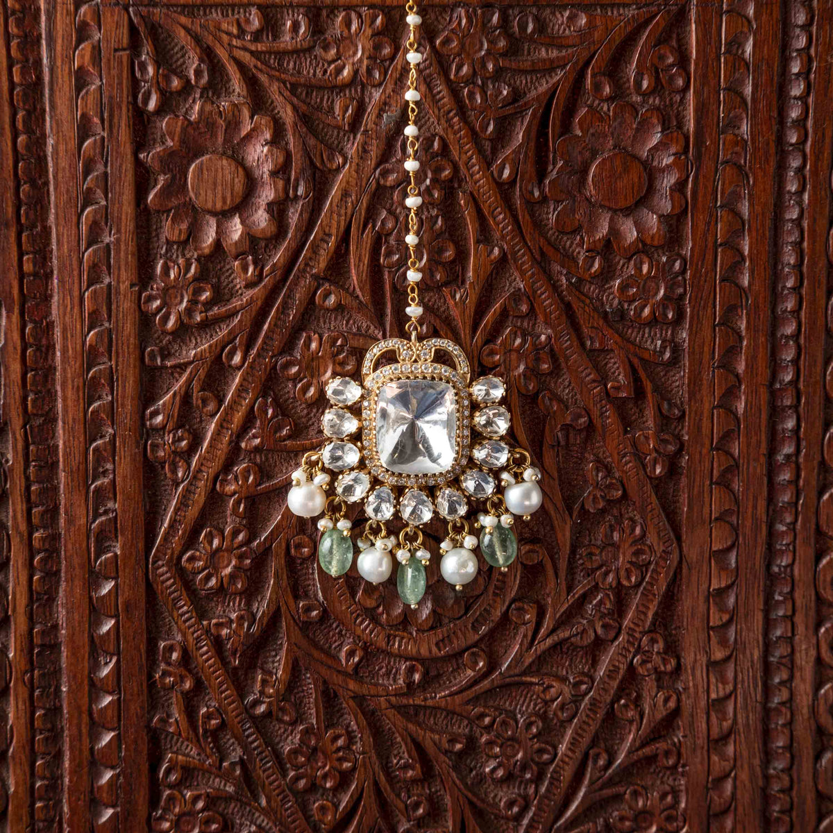 Cushion polki centre inside a polki halo above the freshwater pearl fringe, seen at an angle