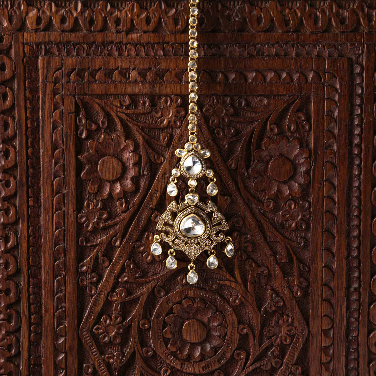 Chand Bali head in uncut polki with CZ pave and a teardrop fringe, seen at an angle