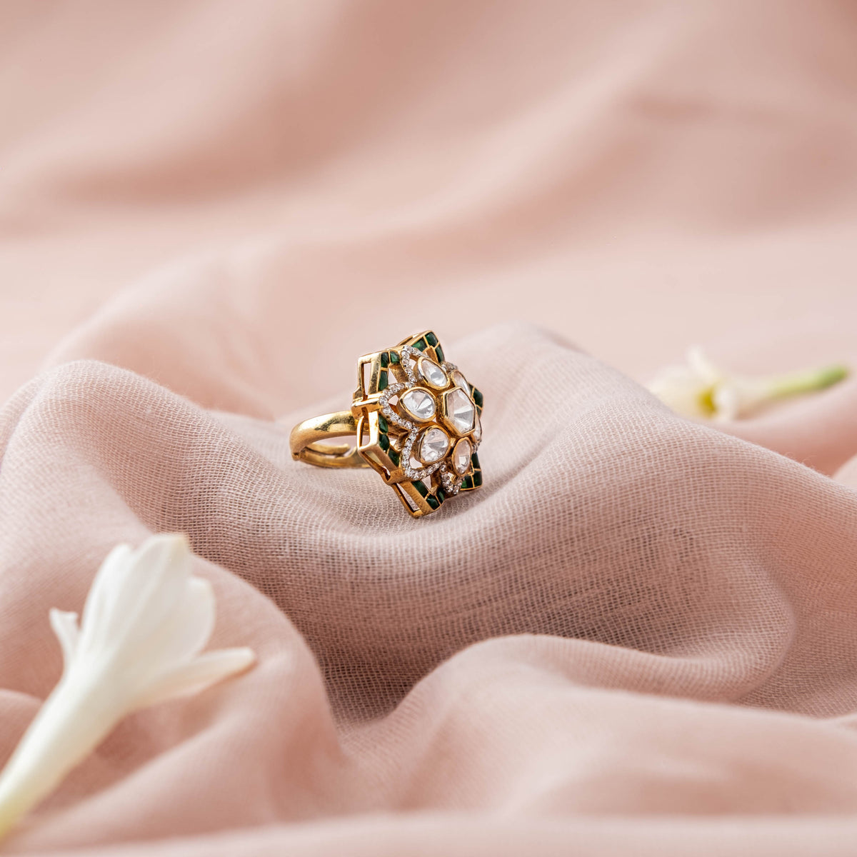 Polki petals framed by green kundan edging, angled on the gold plated cocktail ring