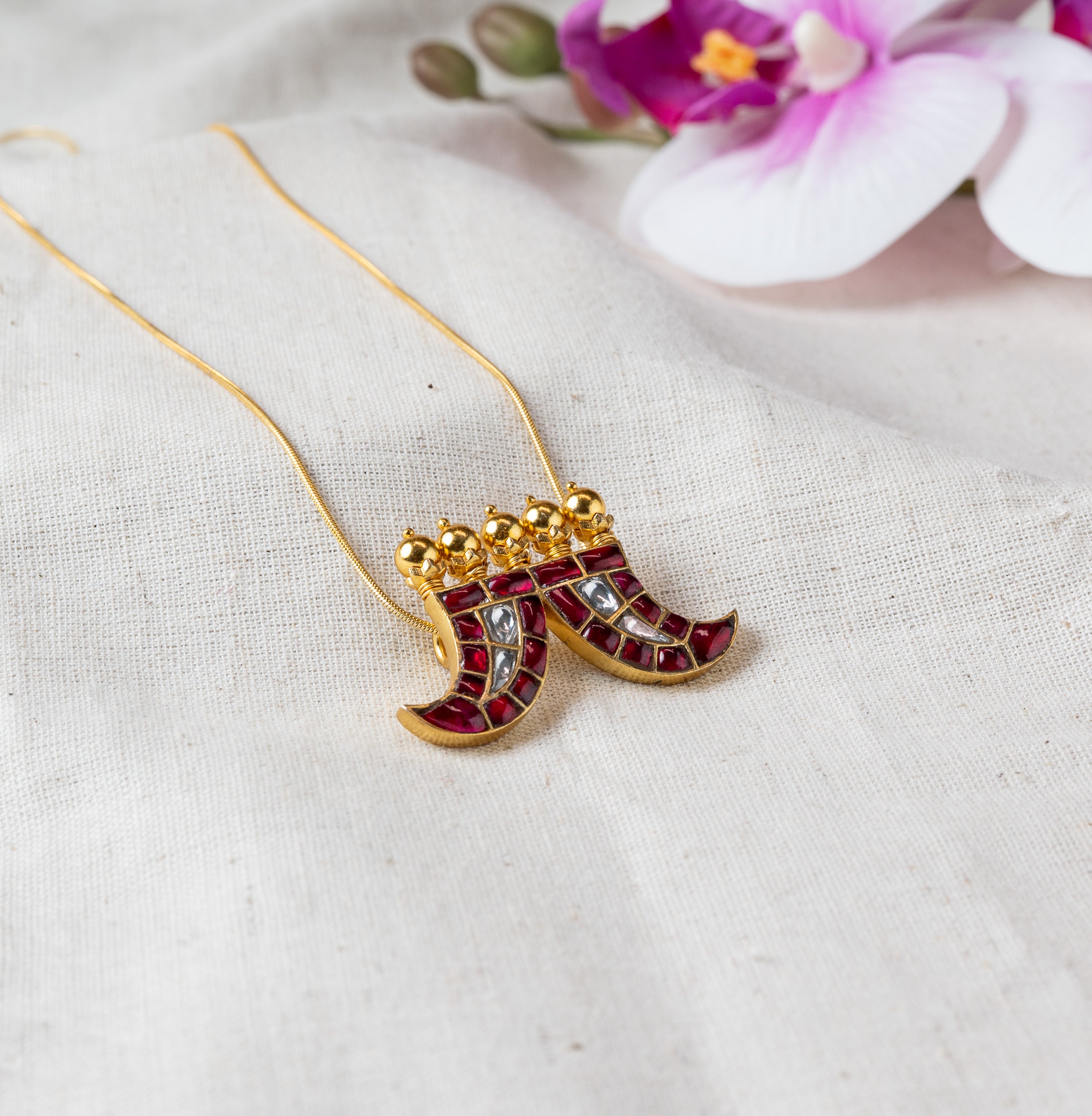 Twin crescent charms in red meenakari with a polki stone stripe, on a gold plated 925 silver chain
