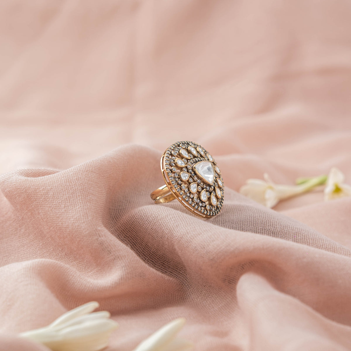 Domed oval face of the teardrop polki ring seen at an angle, Victorian finish 925 silver