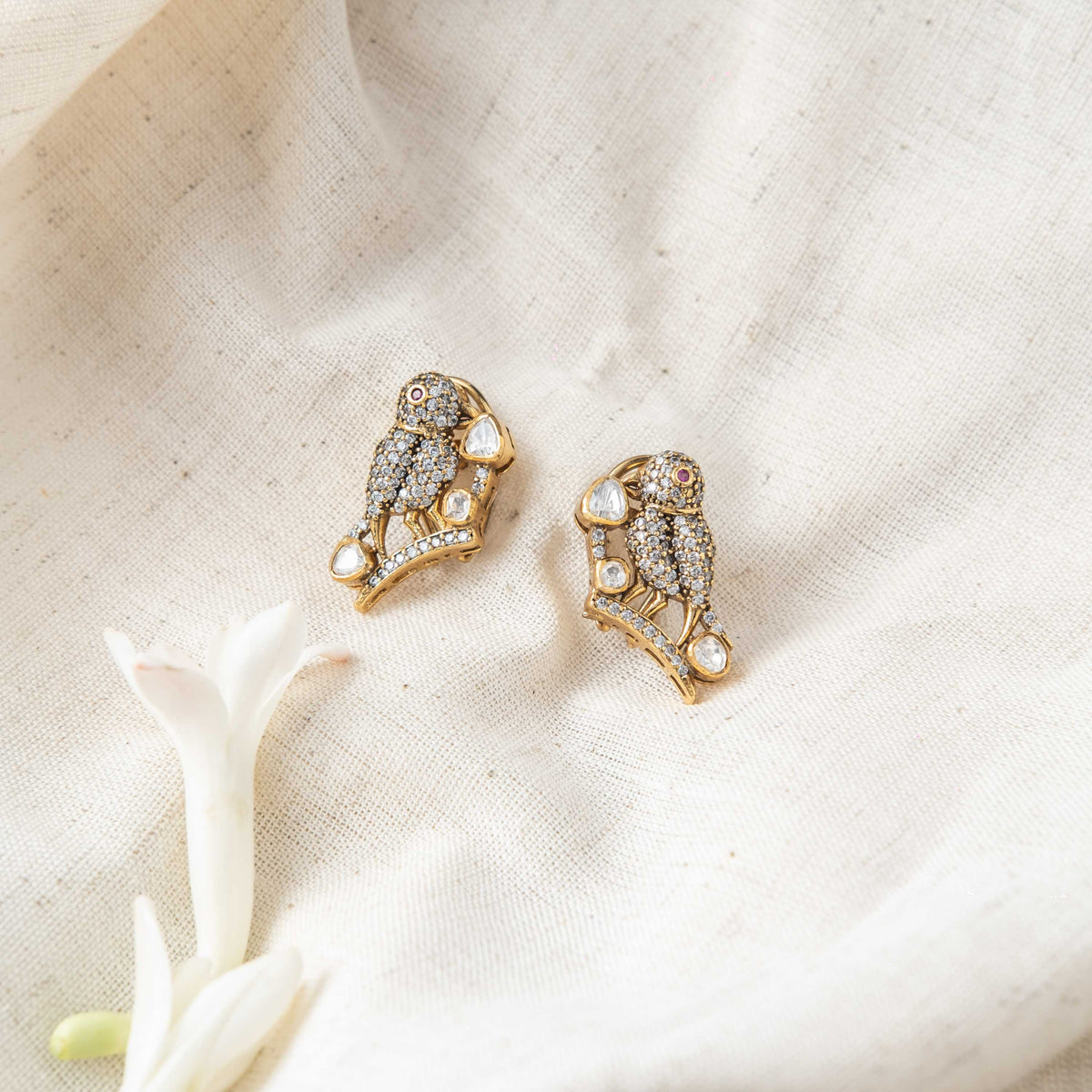Bird motif polki studs with CZ pave and red glass accents in Victorian finish 925 silver