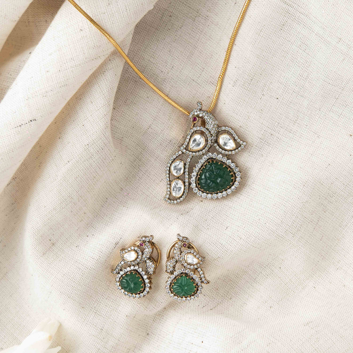 Screw backs with clips behind the peacock studs in Victorian finish polki and CZ