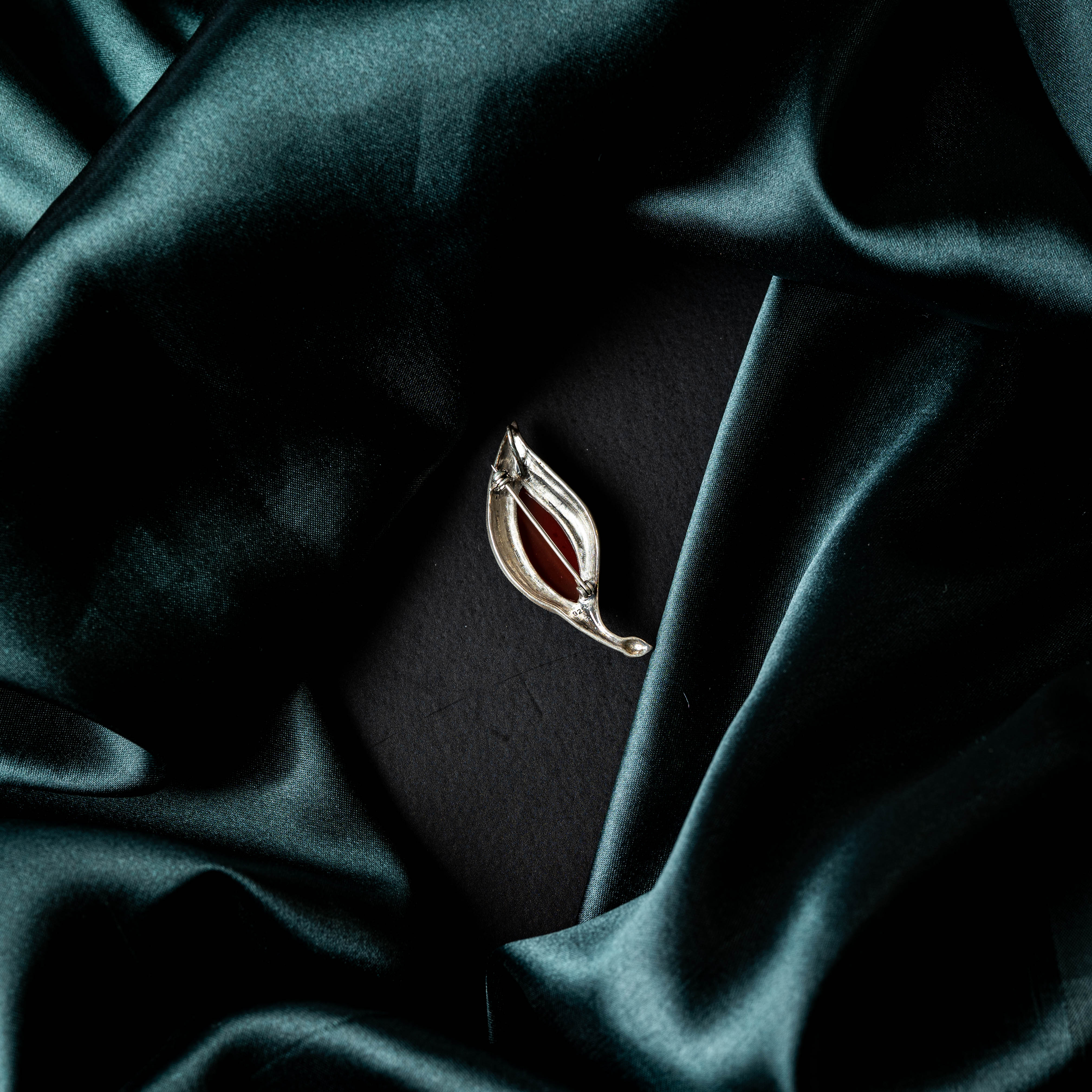 Paisley brooch set with a carved red onyx stone in oxidised 925 silver