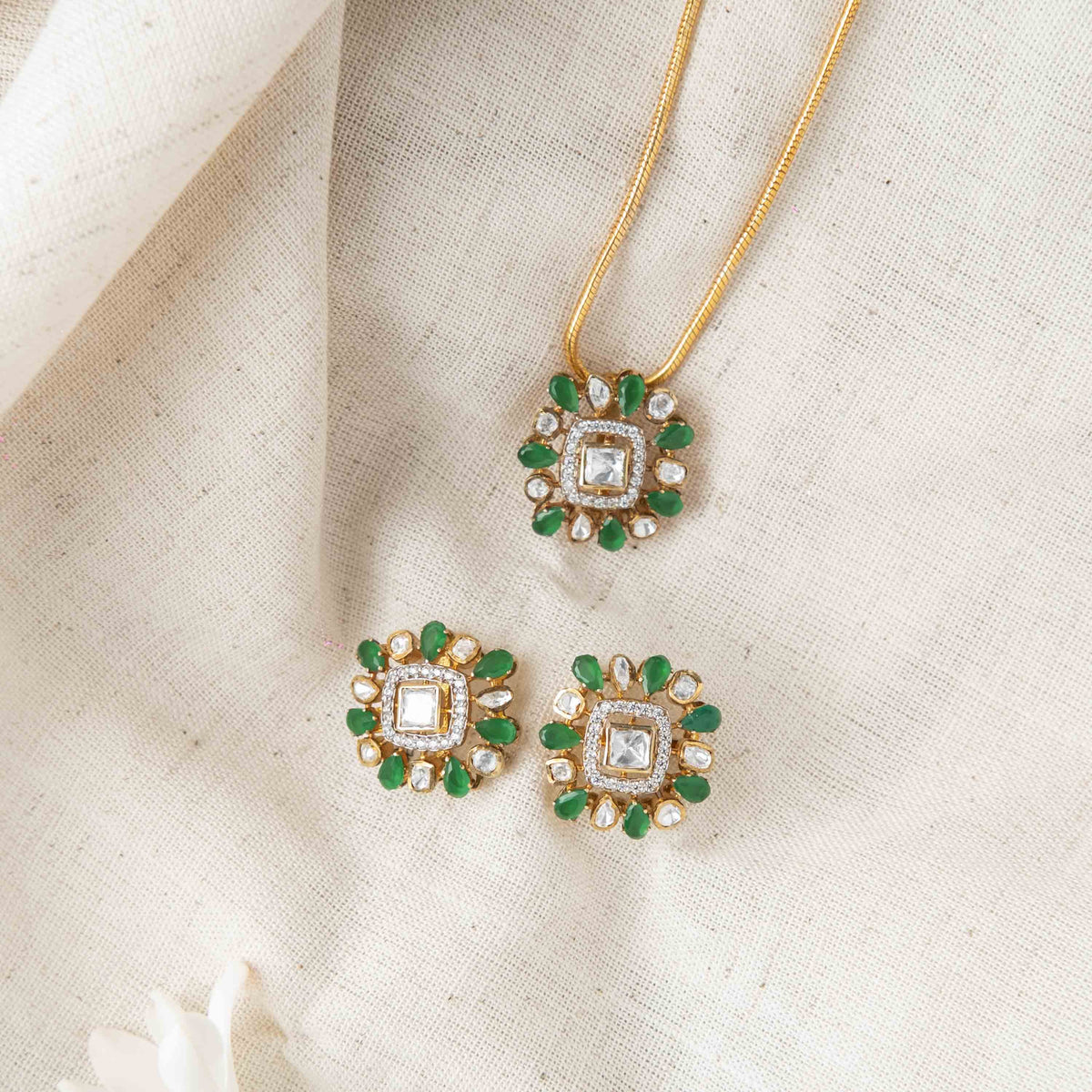 Push back fittings behind the green square studs in gold plated 925 silver