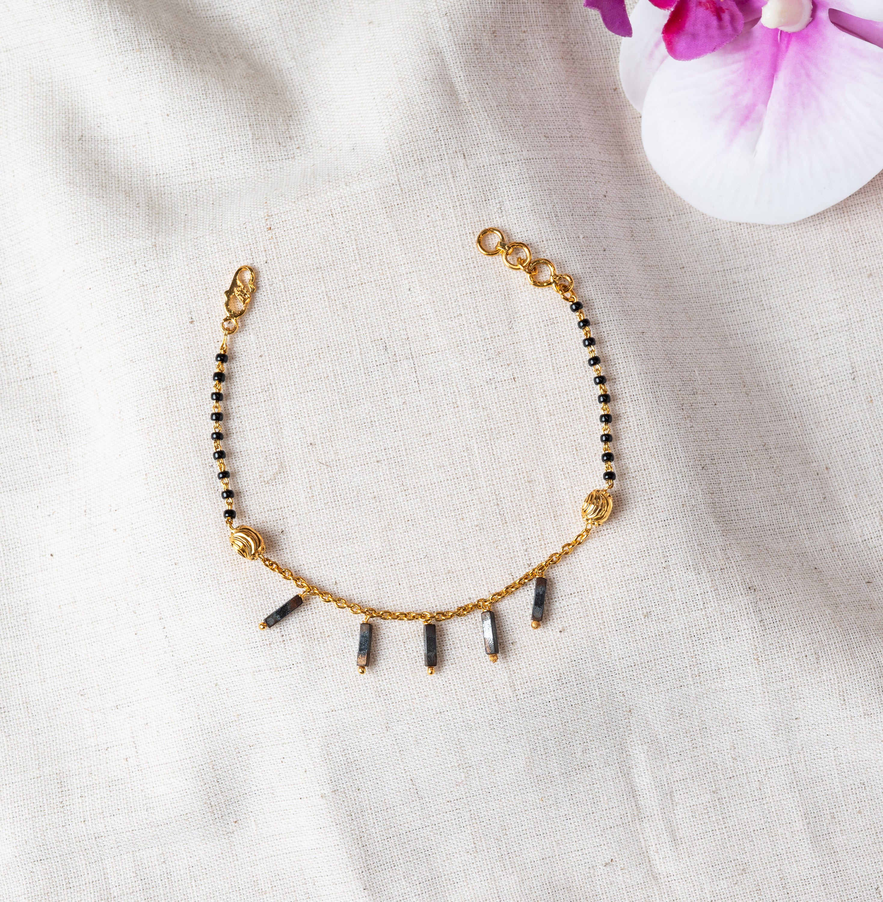 Black bead bracelet with five hanging rectangular charms on gold plated 925 silver chain
