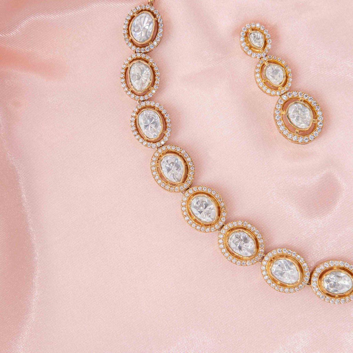 Close view of one graduated polki set into the metal and its CZ border, gold plated 925 silver