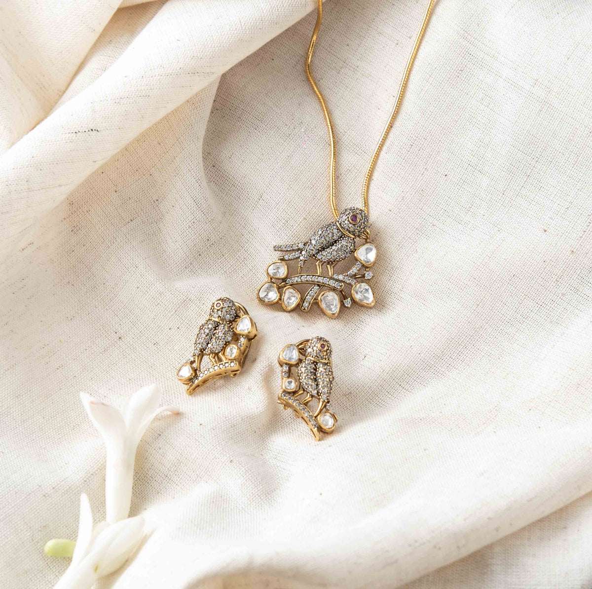 Screw back with clip fitting behind the Victorian finish bird studs in polki and CZ