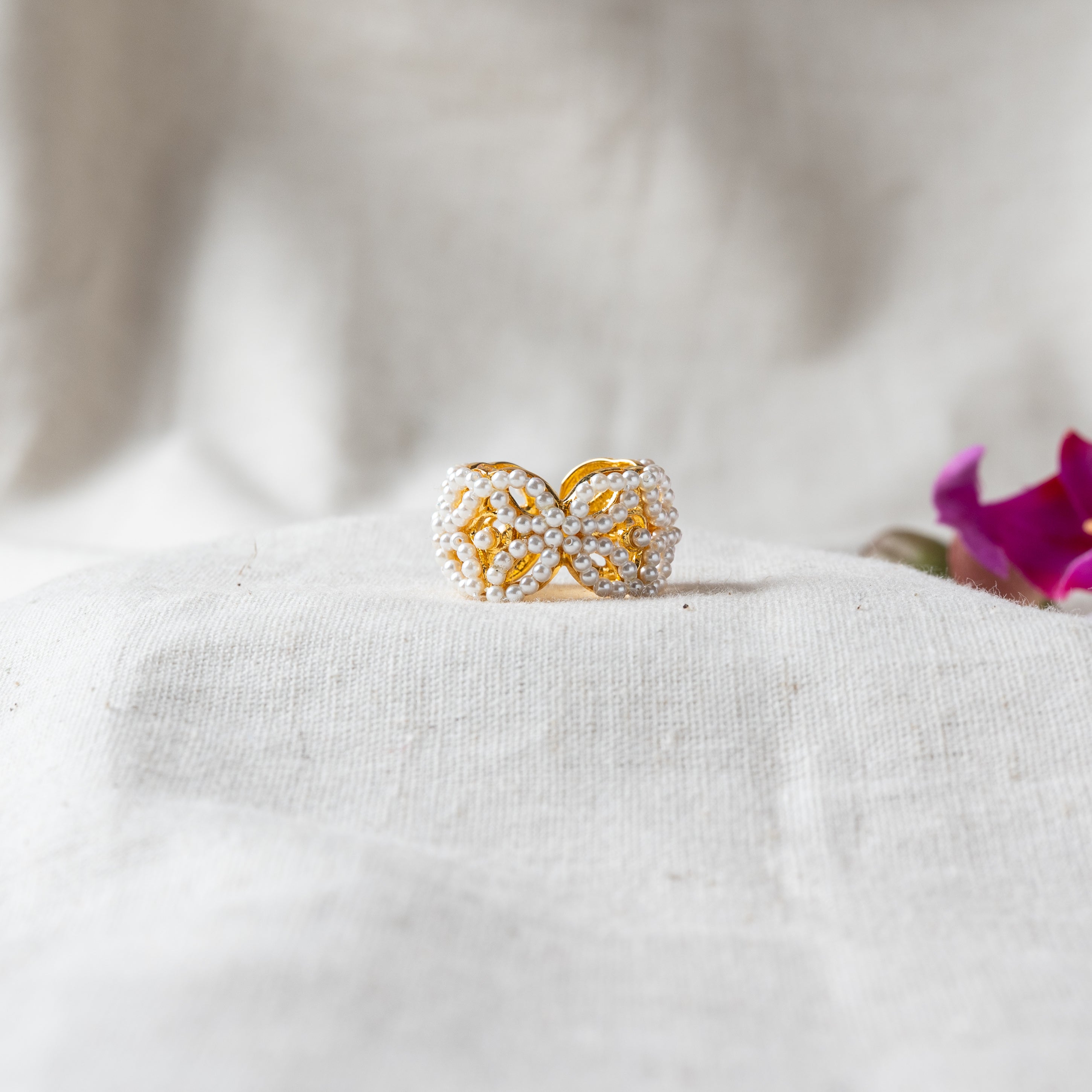 Butterfly ring with wings encrusted in seed pearls over openwork gold plated 925 silver