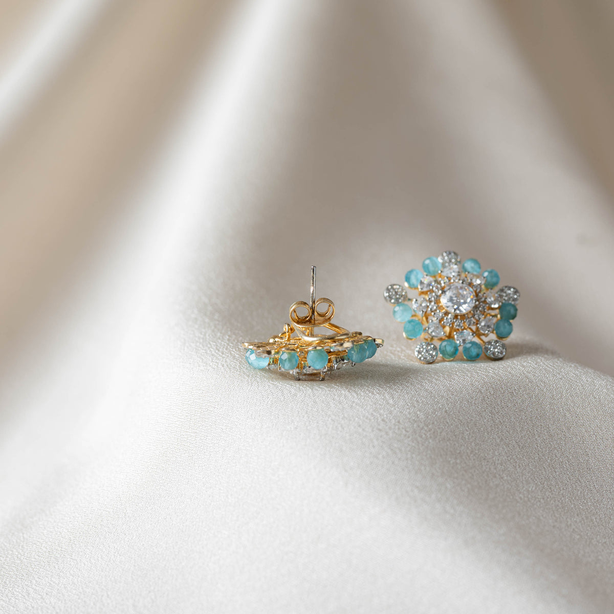 Close view of the push back and clip behind an aqua blue crystal bead stud in gold plated 925 silver