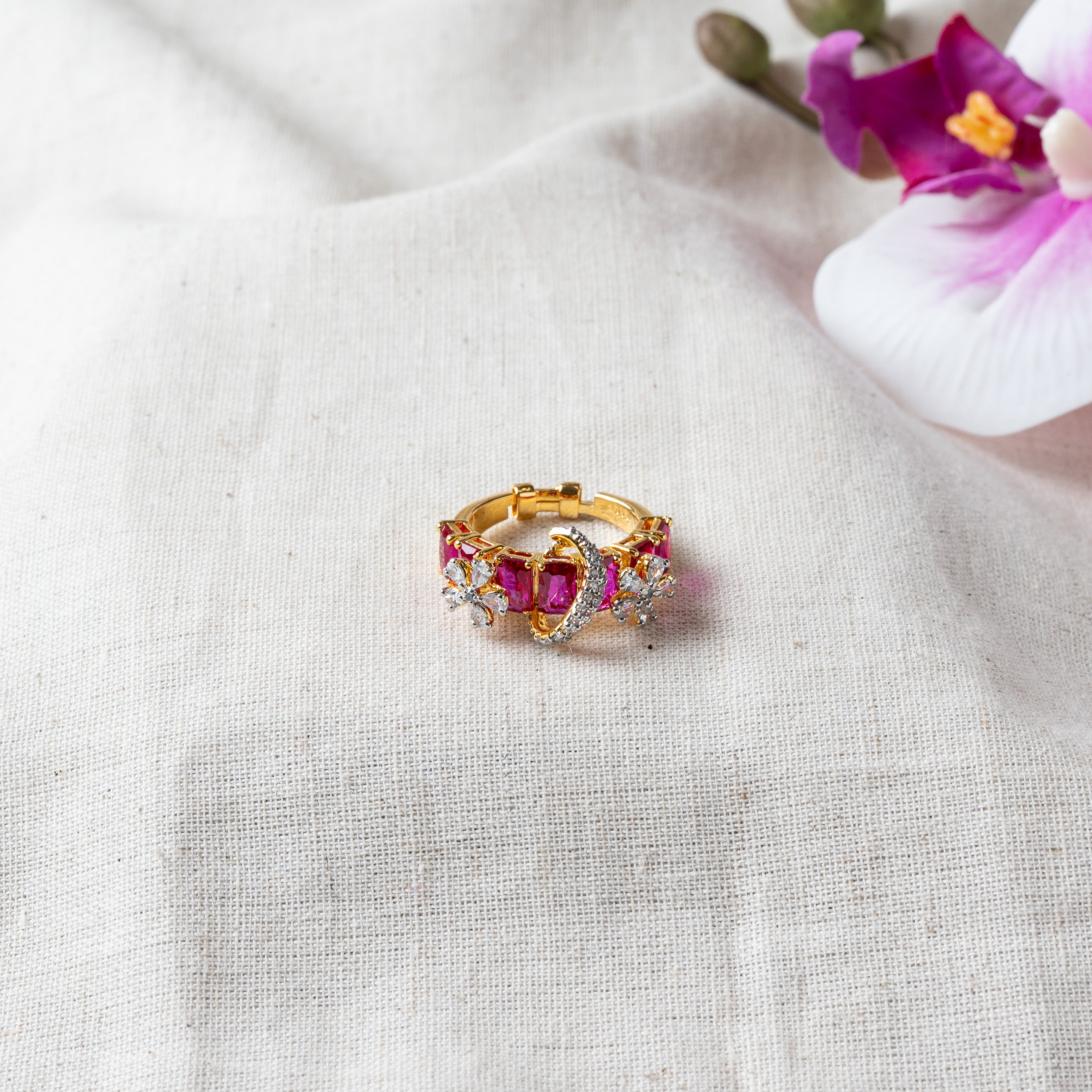 Close view of the crossover CZ band between rows of red ruby stones, gold plated 925 silver