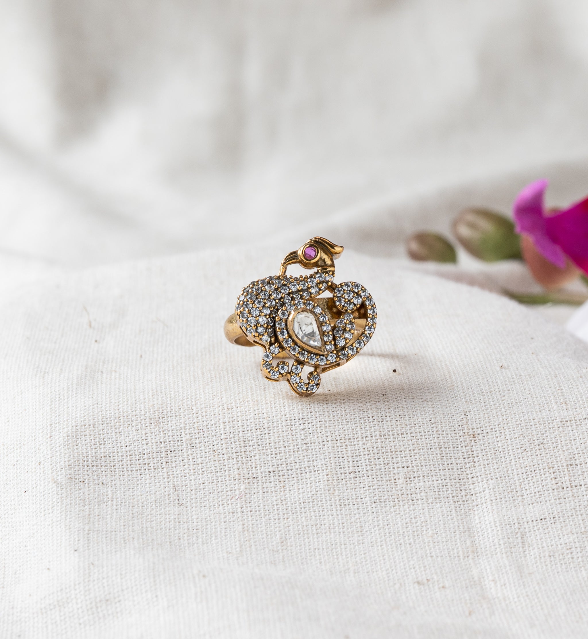 Victorian peacock ring with a pear cut white polki and a ruby eye in victorian plated 925 silver