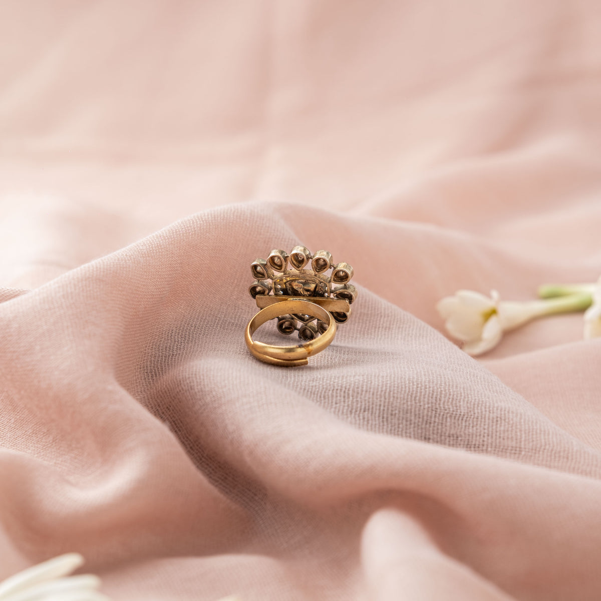 Foil-backed petal settings and open band of the floral ring from the side, Victorian finish silver