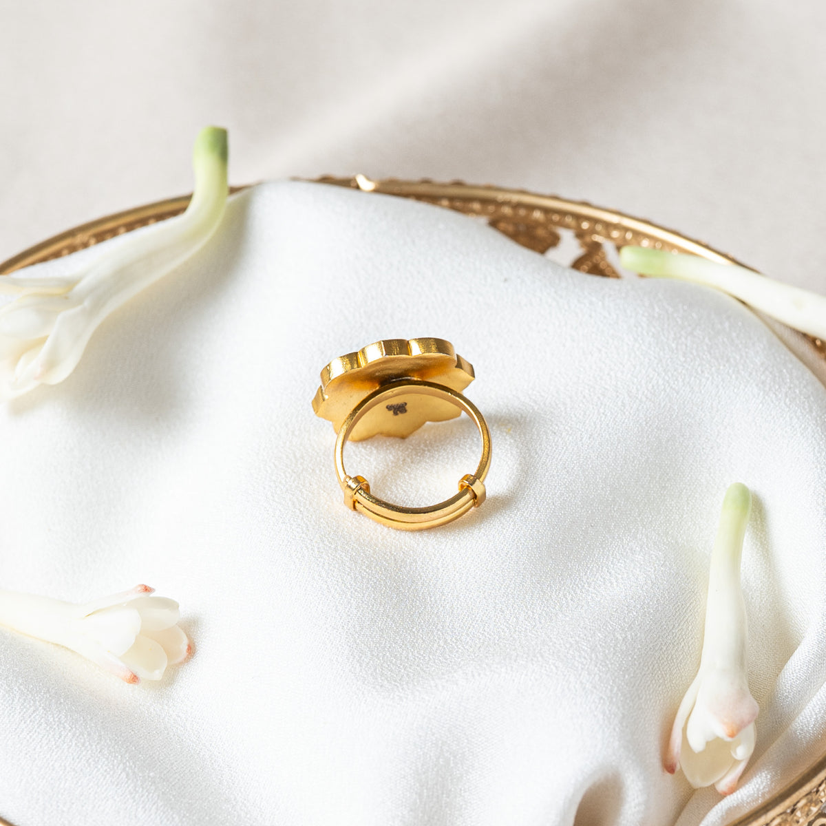 Back of the navratna ring showing the sliding tail of the band and the two small loops it runs through