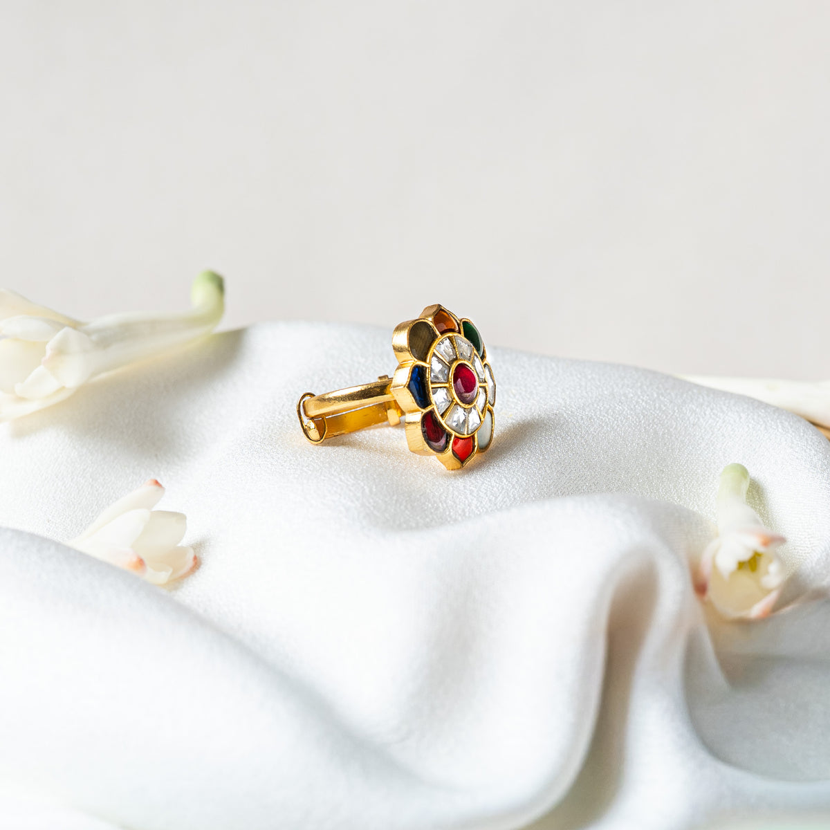 Side view of the navratna ring showing the level flat cut face and the sliding band beneath