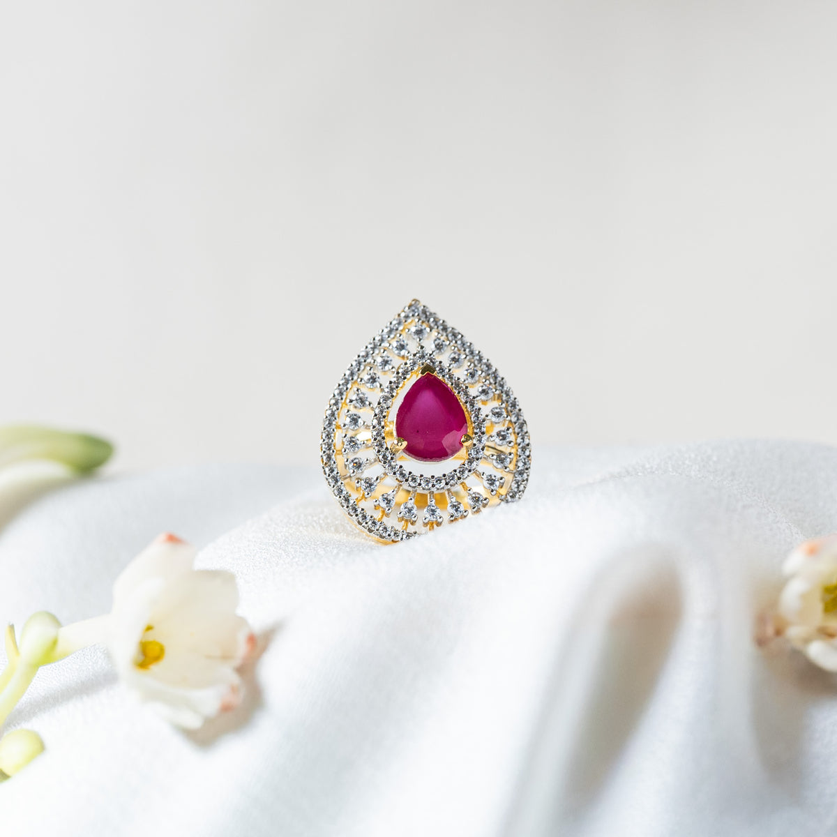 Pink pear cut stone in a teardrop of white CZ, gold plated 925 silver cocktail ring