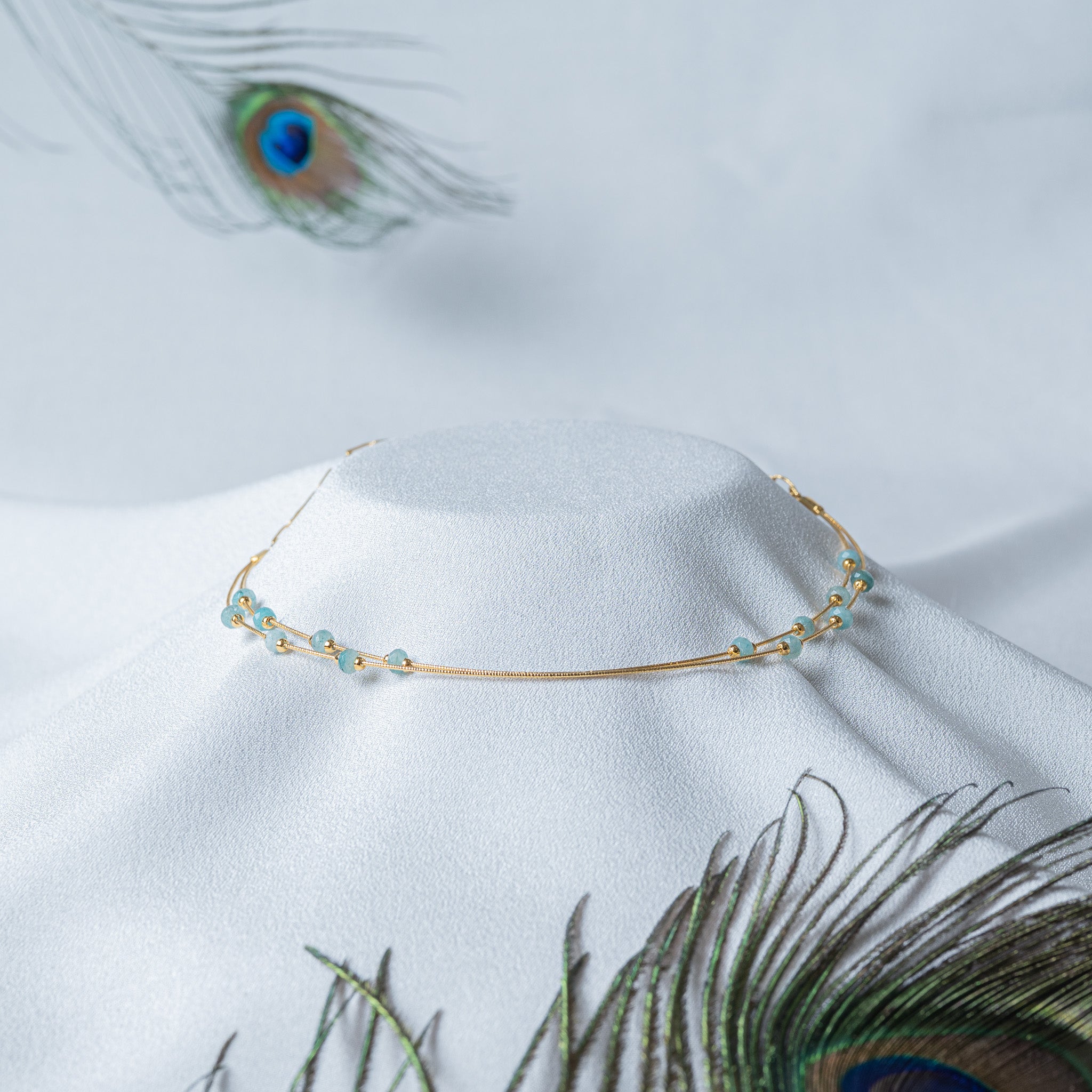 Pale aqua faceted beads set as stations on two gold snake strands, 925 silver collar