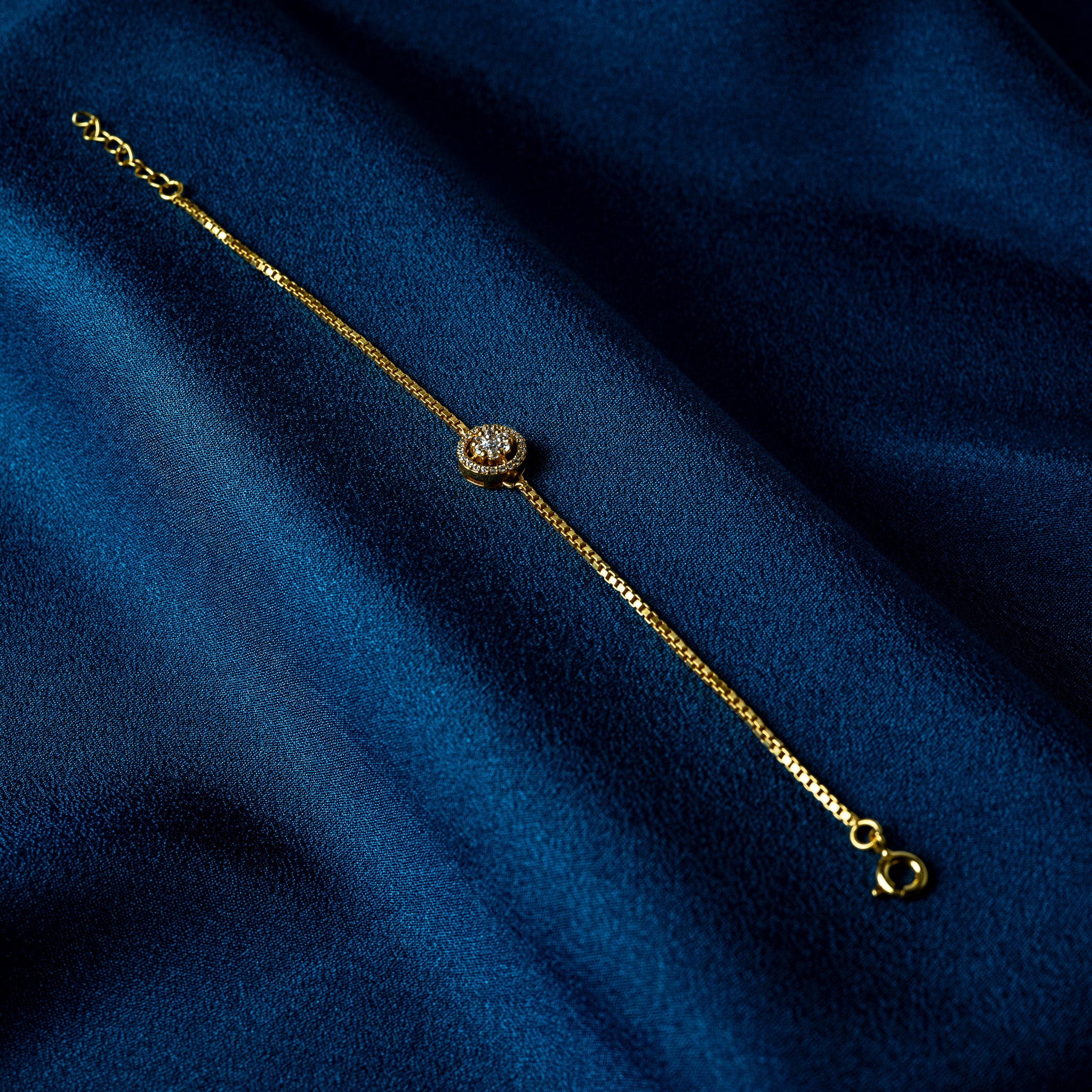 CZ halo bracelet in gold plated 925 silver, a seven stone cluster floating inside a pave ring