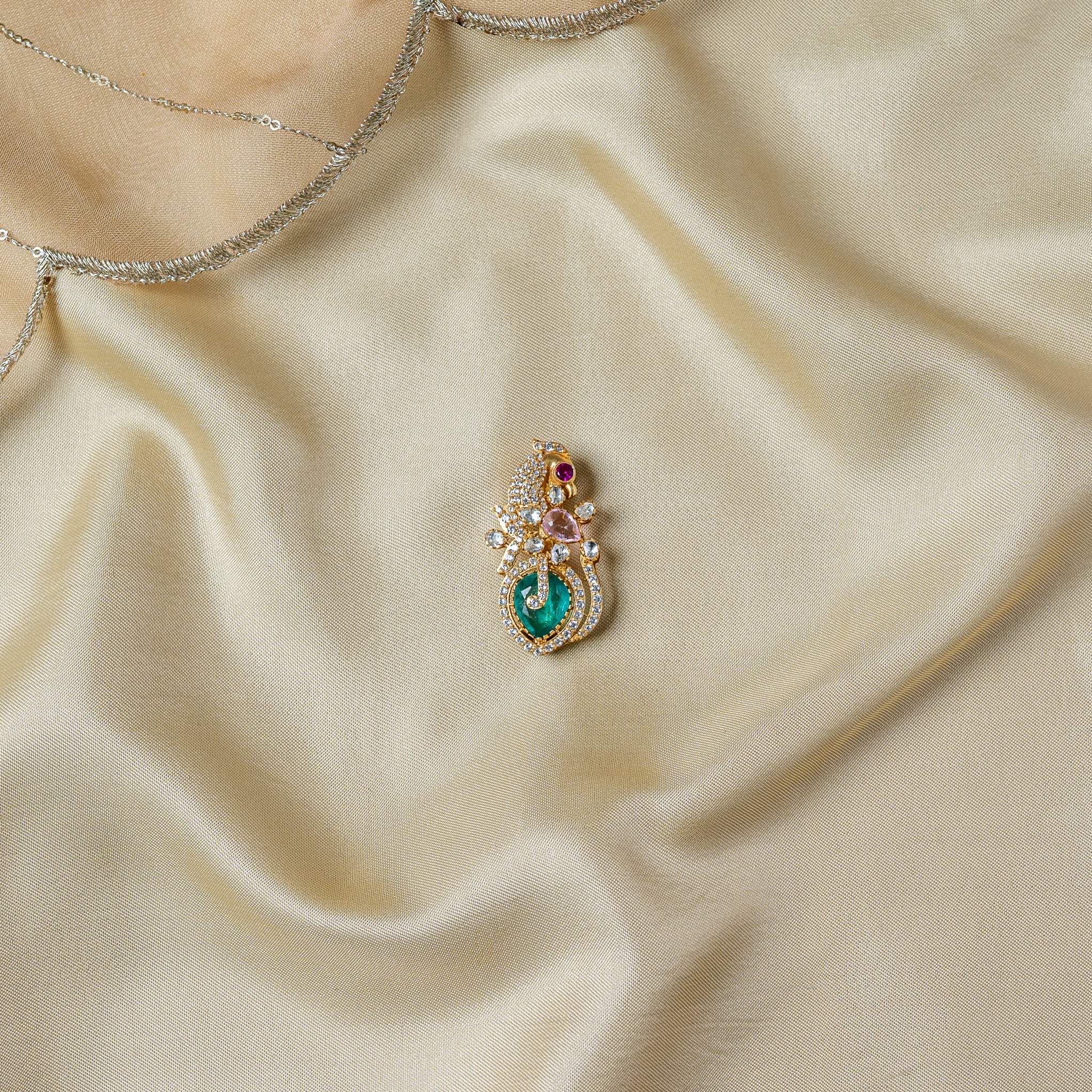 Peacock and paisley brooch with a magenta eye stone and a large green plume stone, gold plated 925 silver